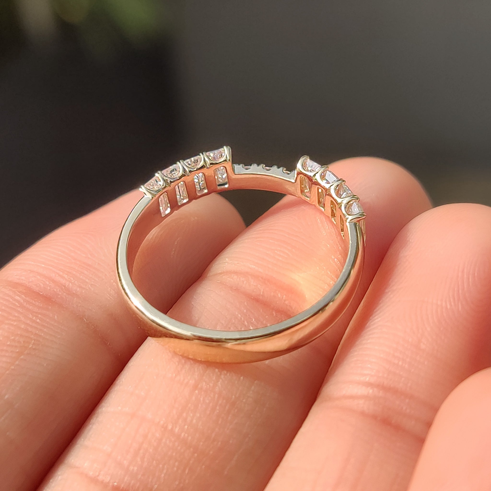 Stackable wedding band with balanced emerald and round diamond.
