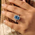 Blue oval halo ring with IGI certified diamond
