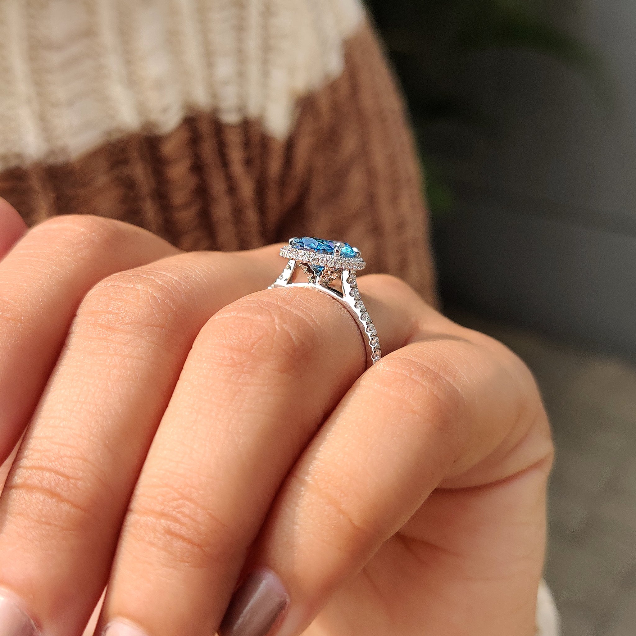 Blue diamond ring with round cut pave band
