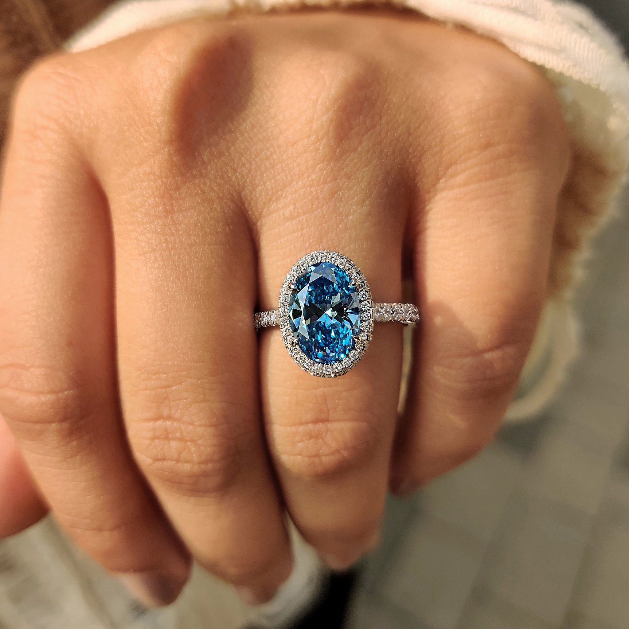 Lab grown blue oval diamond engagement ring
