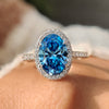 Blue diamond halo ring in white gold
