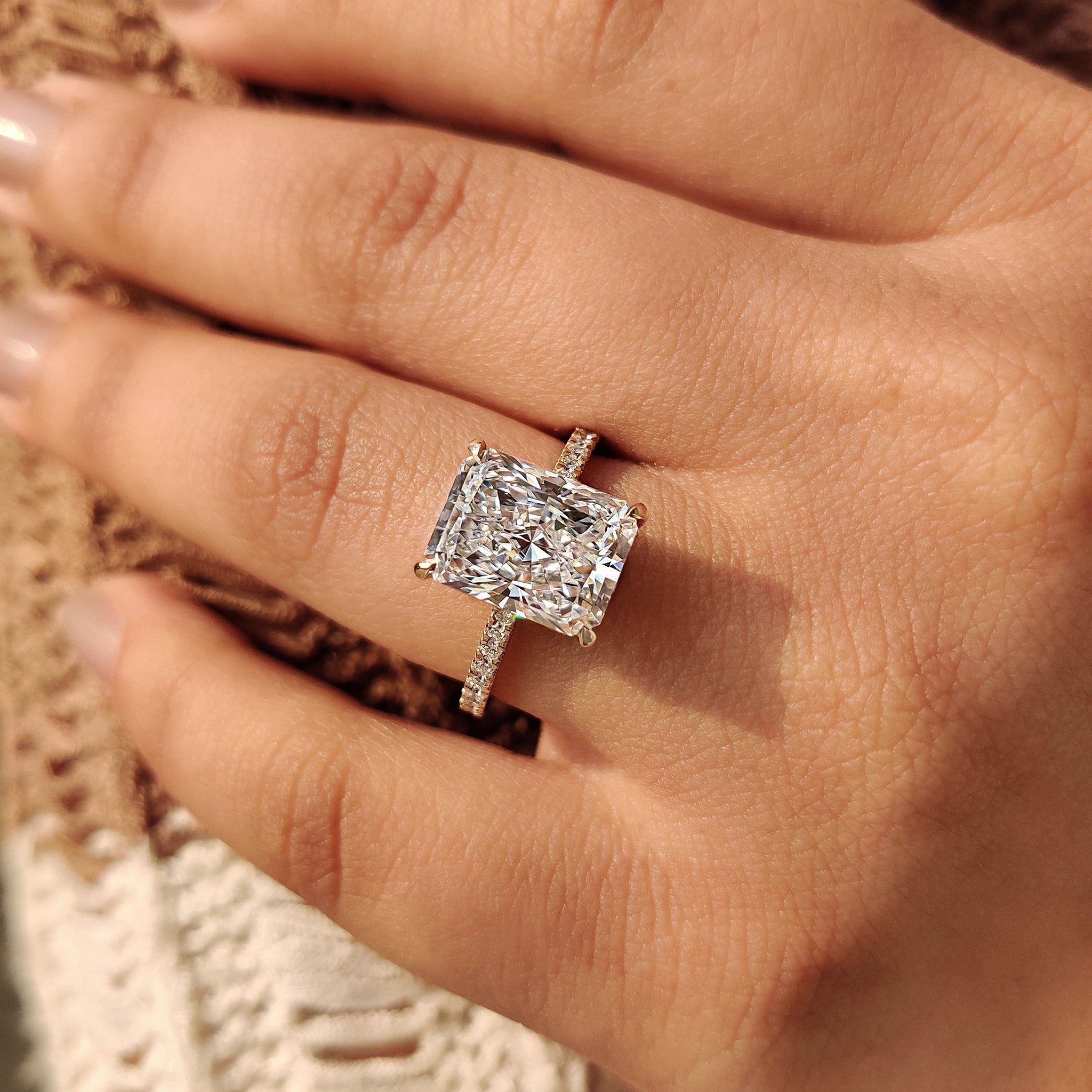 Yellow gold radiant diamond ring with four claw setting
