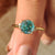 Cyan blue Portuguese cut moissanite ring in a four-claw prong setting
