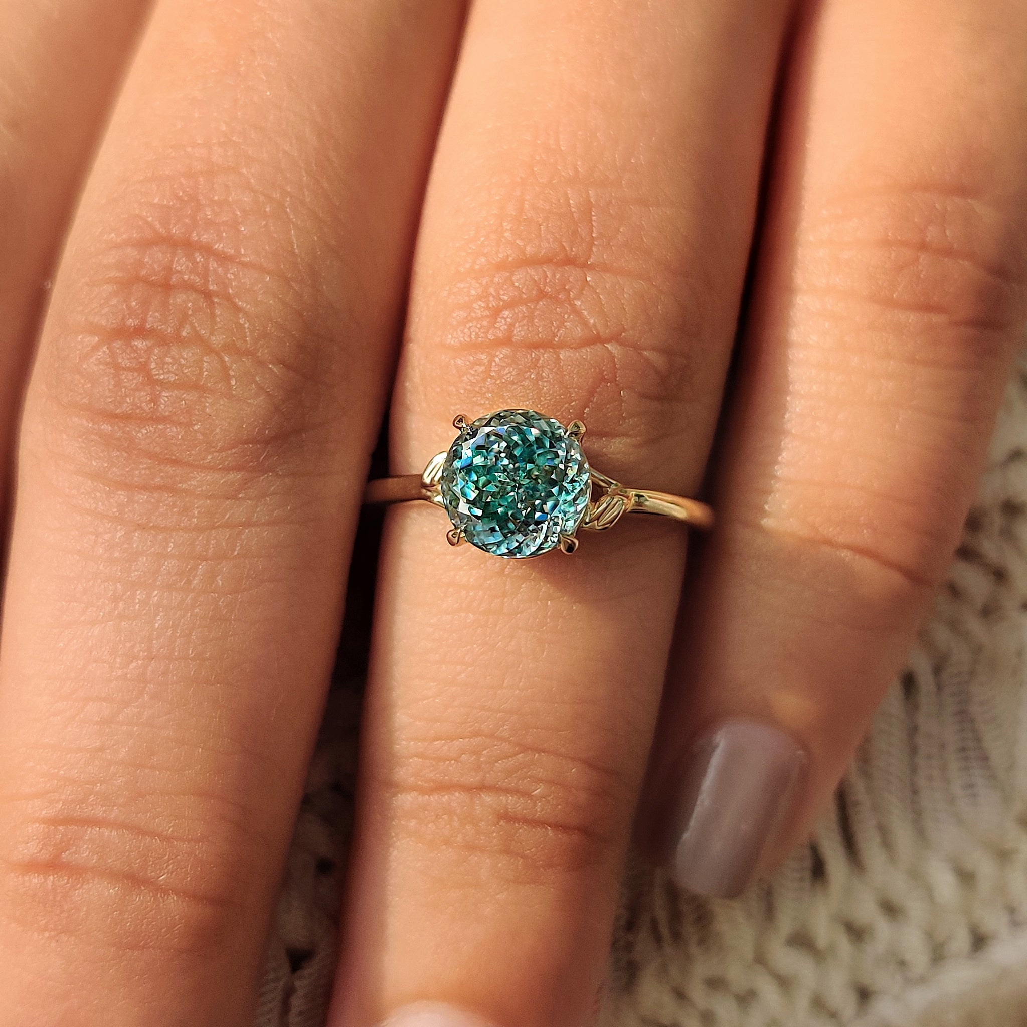 Four-claw prong setting moissanite ring in cyan blue
