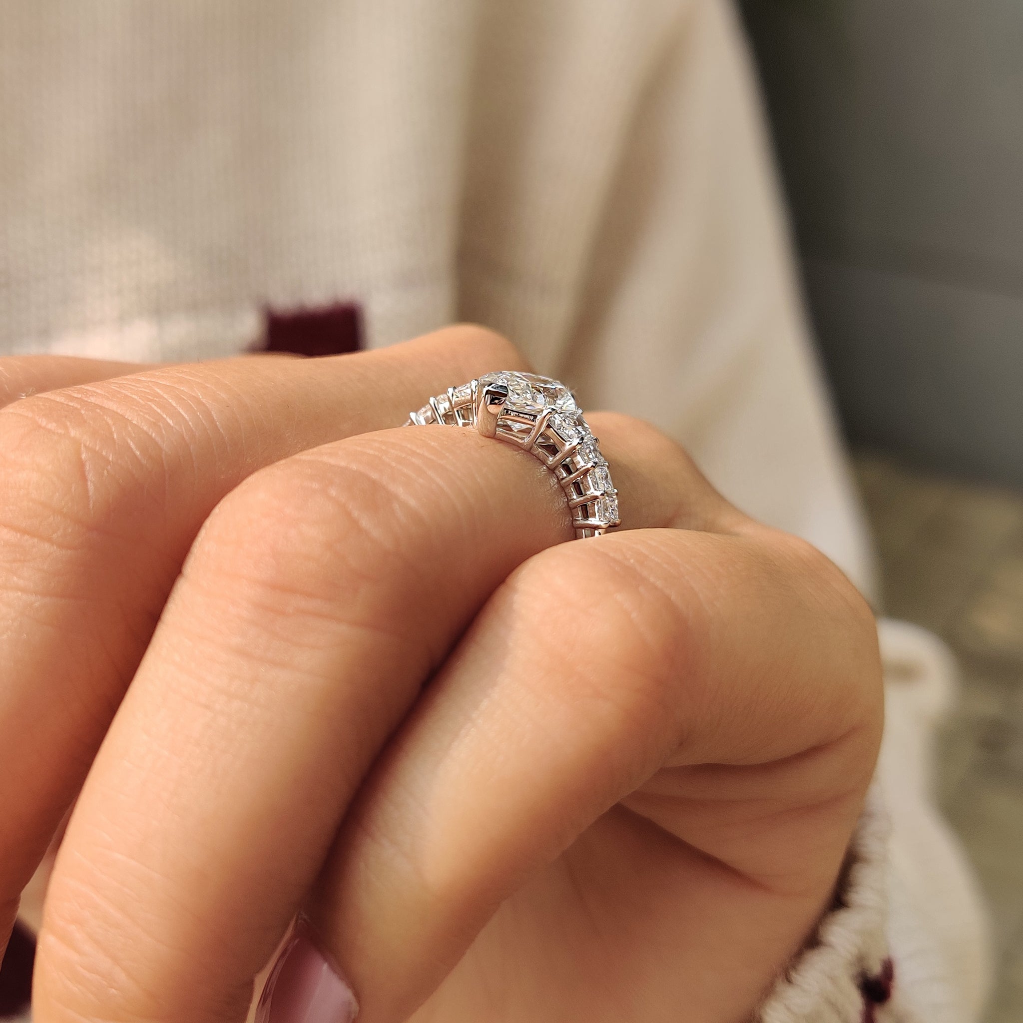 Custom diamond ring with princess and trapezoid side stones.
