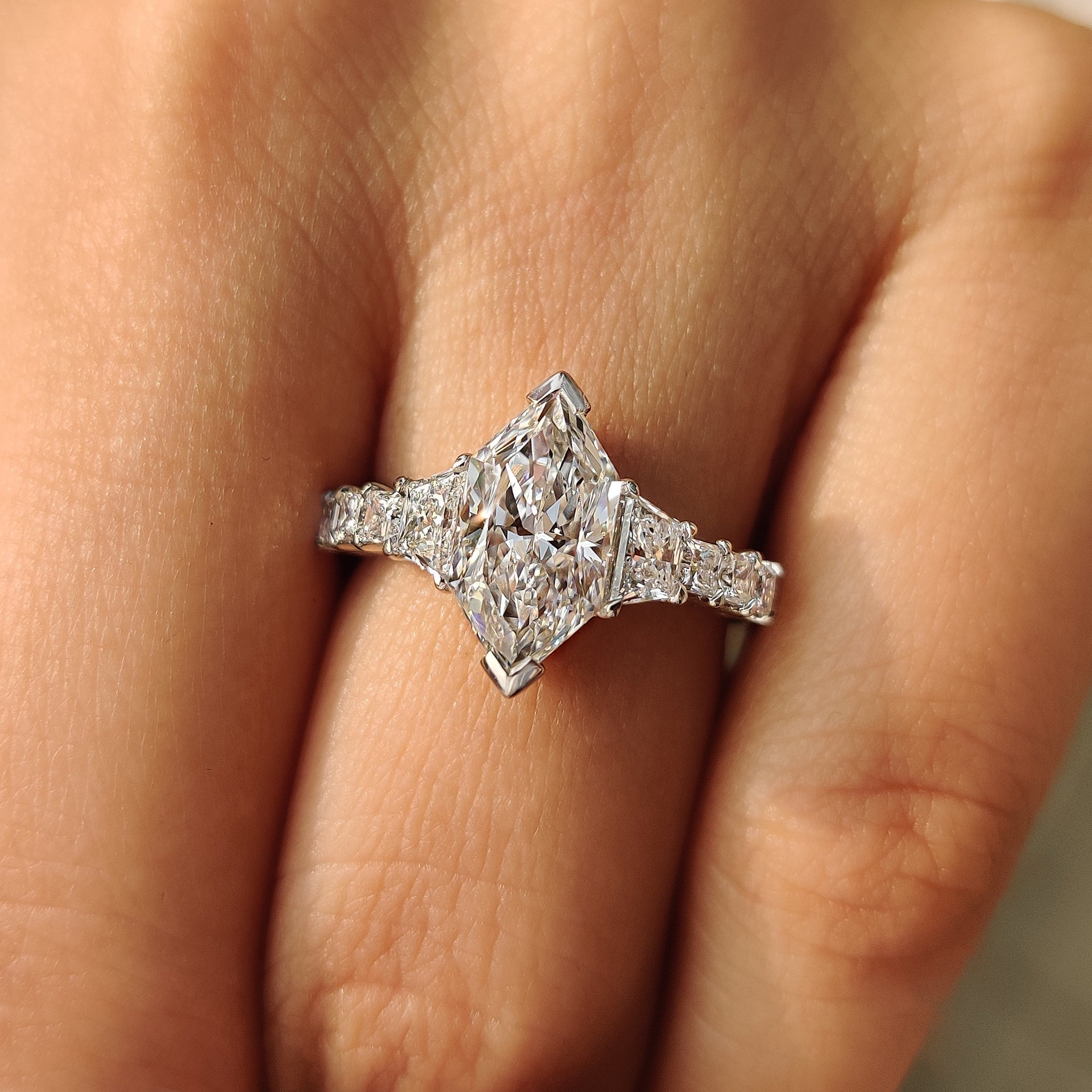 Side stone ring with dutch marquise center diamond.
