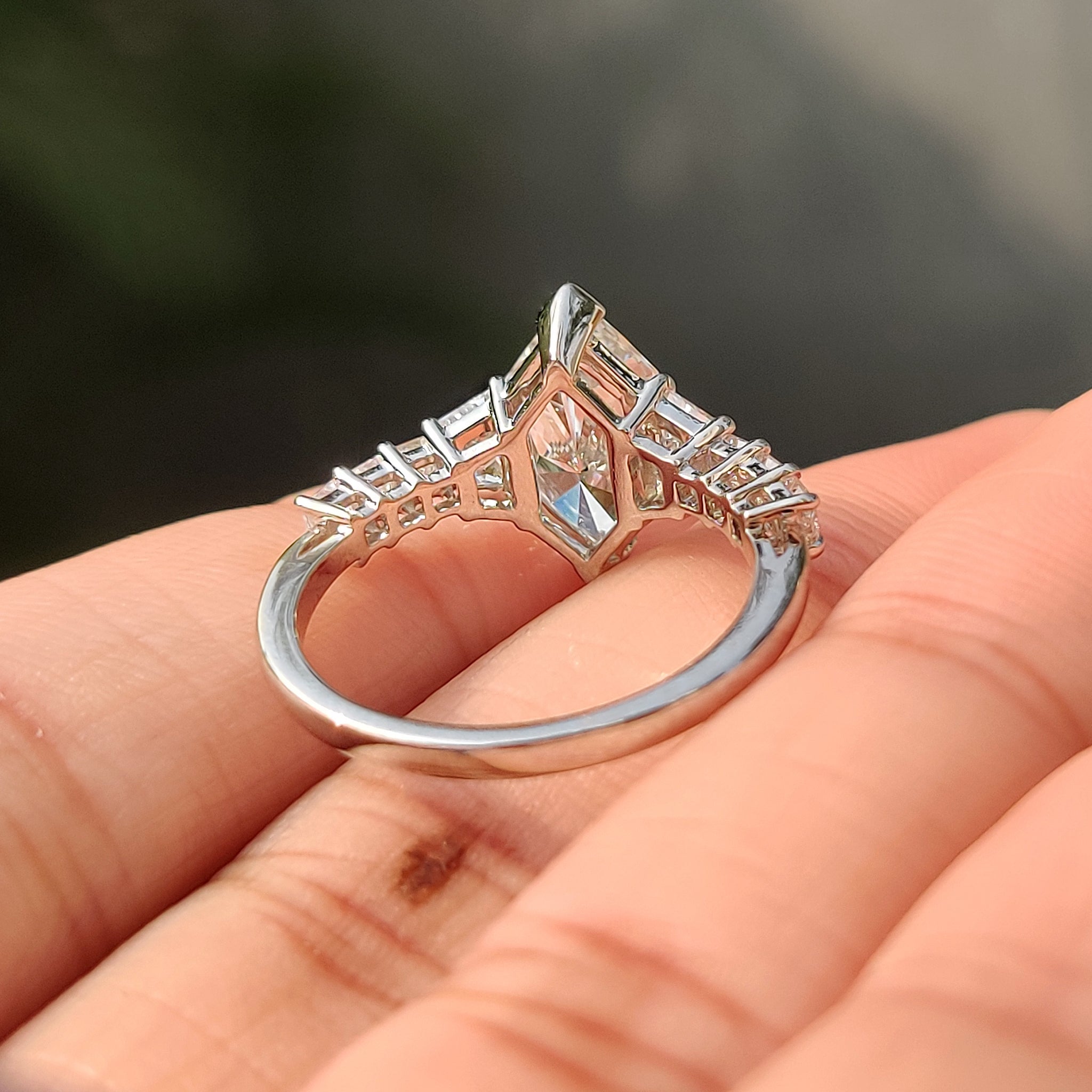 V shaped prong ring holding a dutch marquise center stone.
