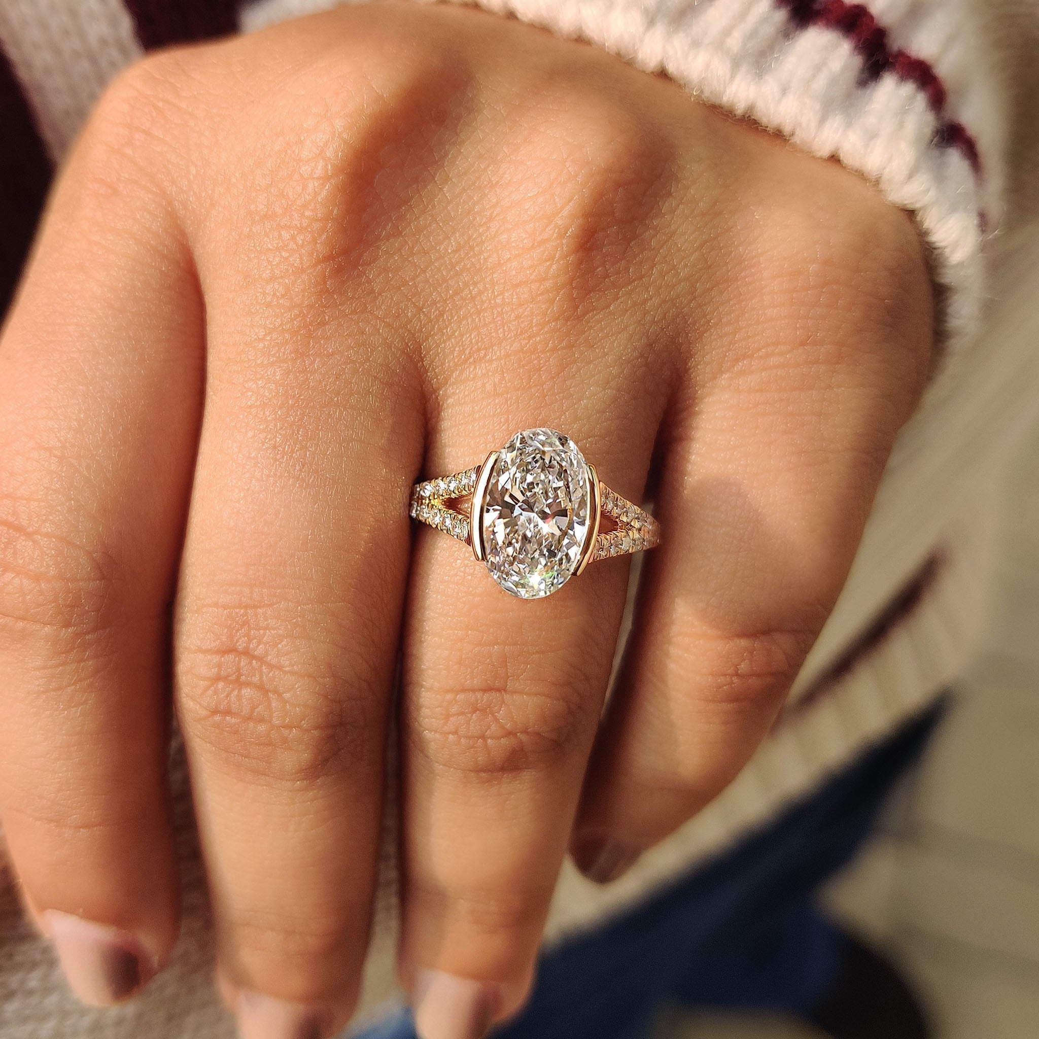 Yellow gold oval ring with round cut side stones
