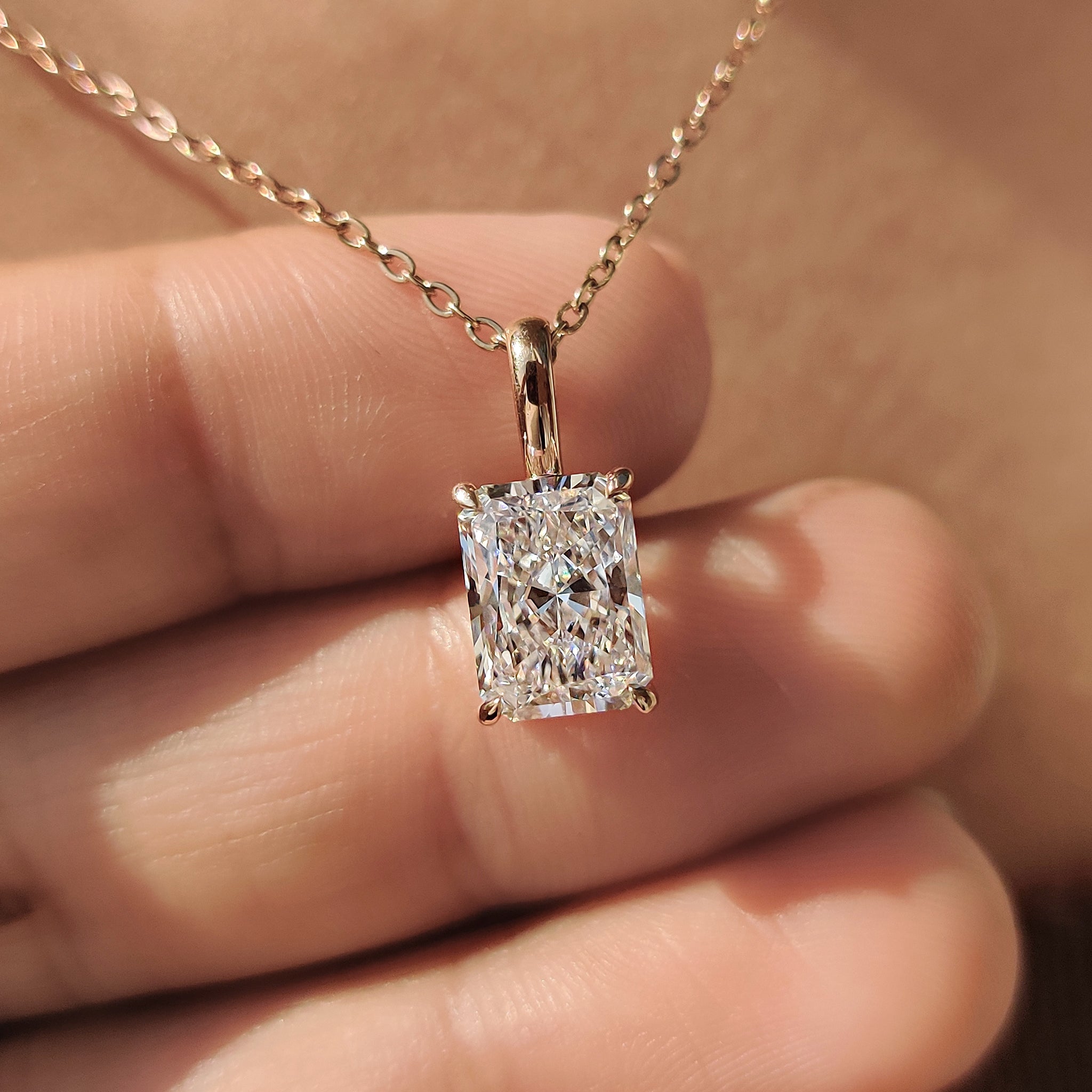 Unique diamond pendant featuring solitaire pendant.
