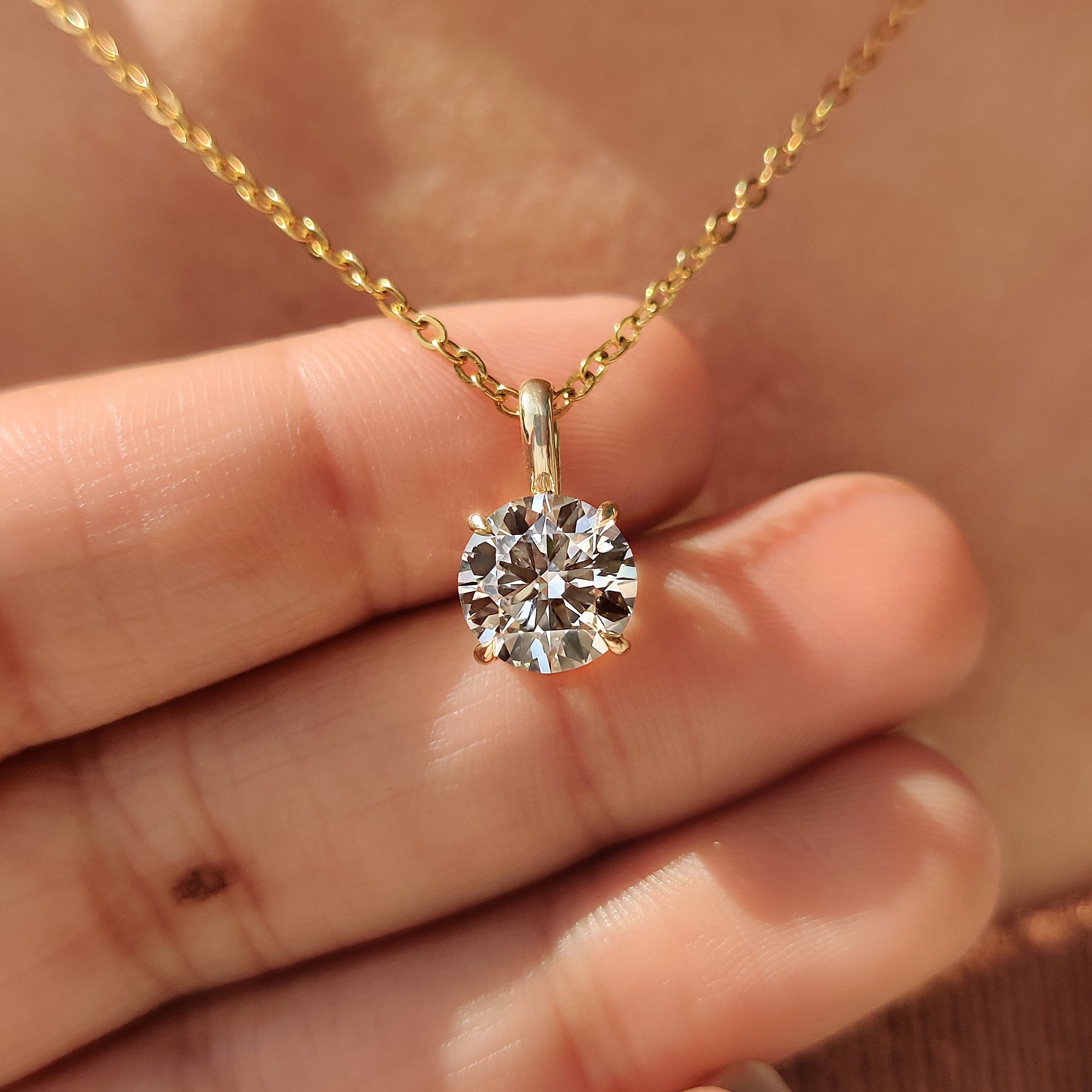 Unique diamond pendant featuring solitaire diamond pendant.
