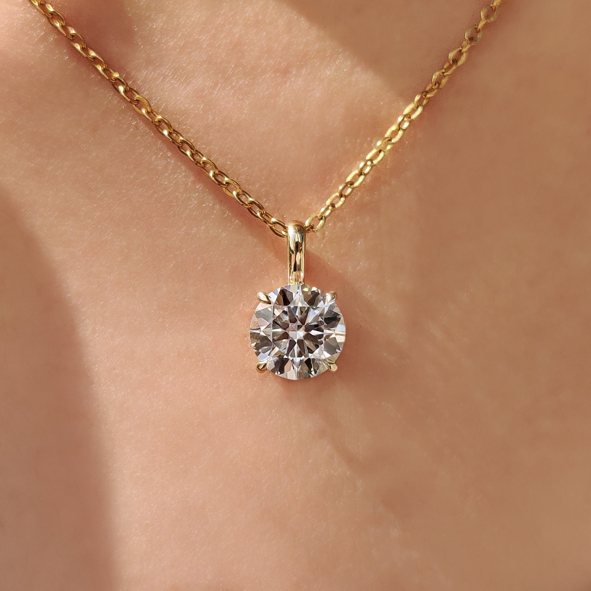 Round diamond pendant with round cut solitaire pendant.
