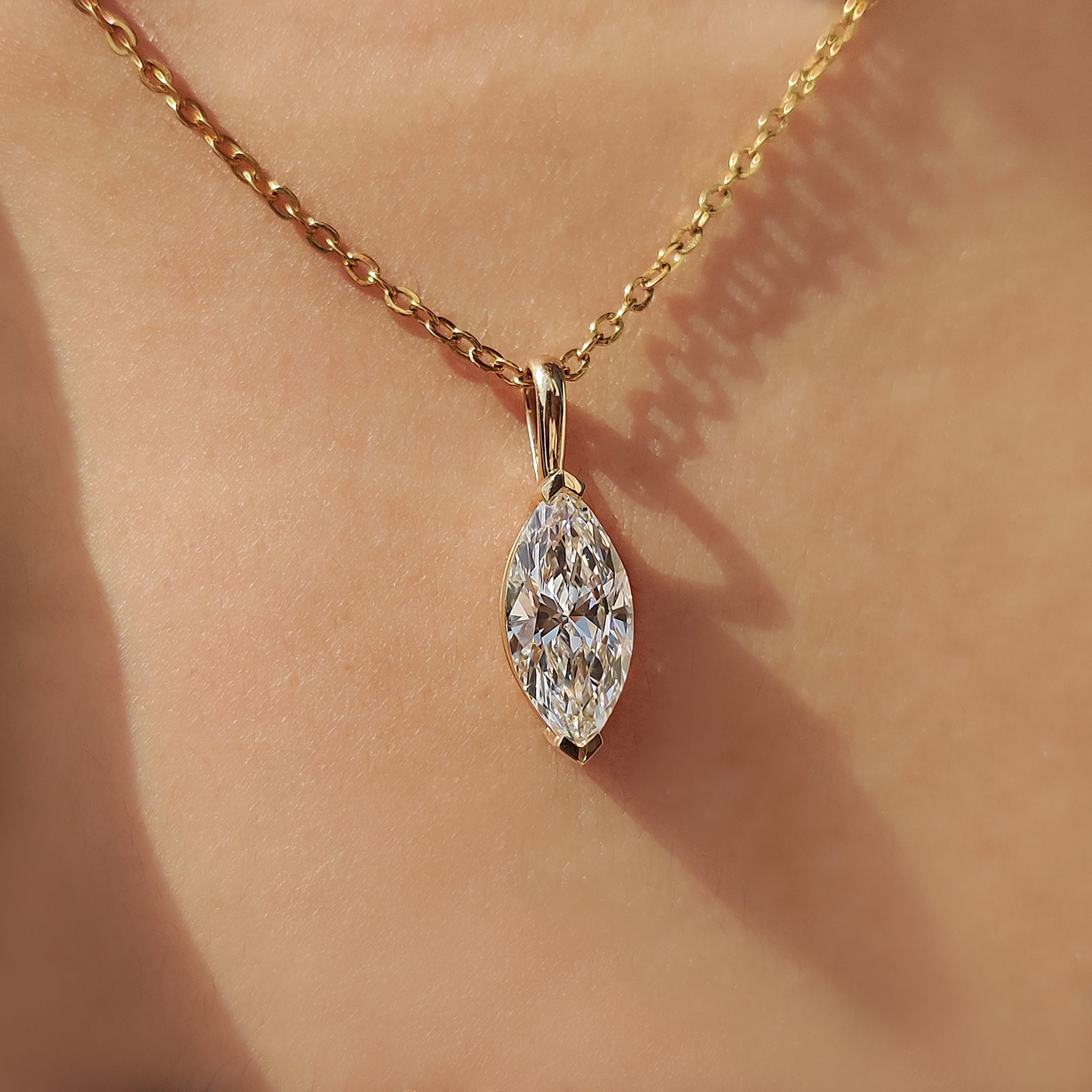 Marquise diamond pendant with solitaire diamond pendant.
