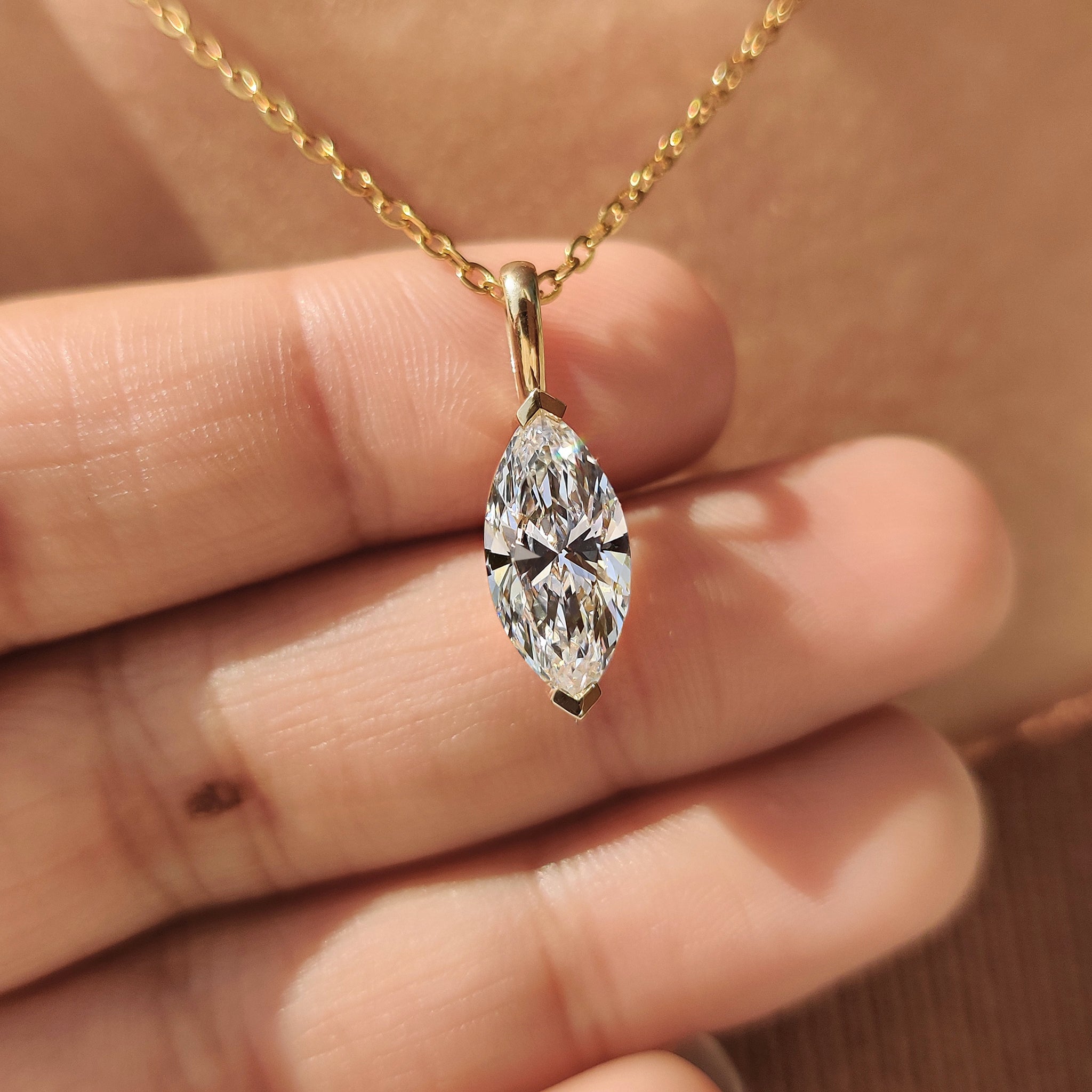 Unique diamond pendant with V prong setting.
