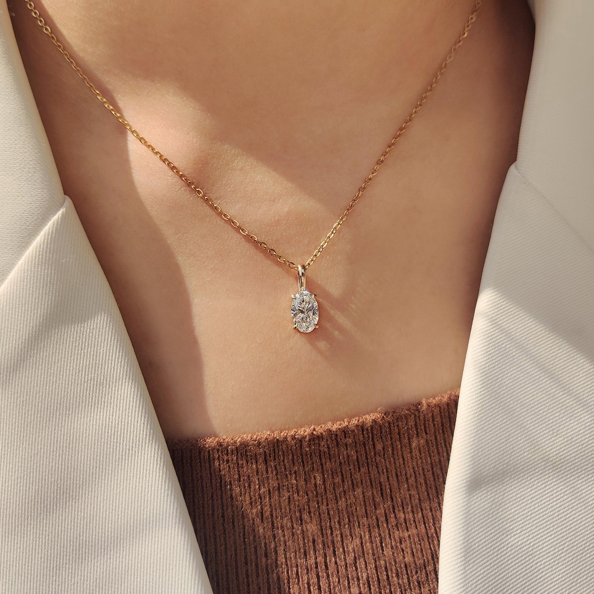 Handmade jewelry featuring oval diamond pendant.
