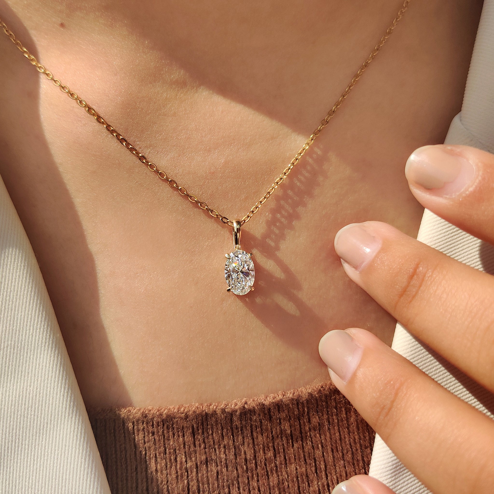 Unique diamond pendant featuring oval diamond pendant.
