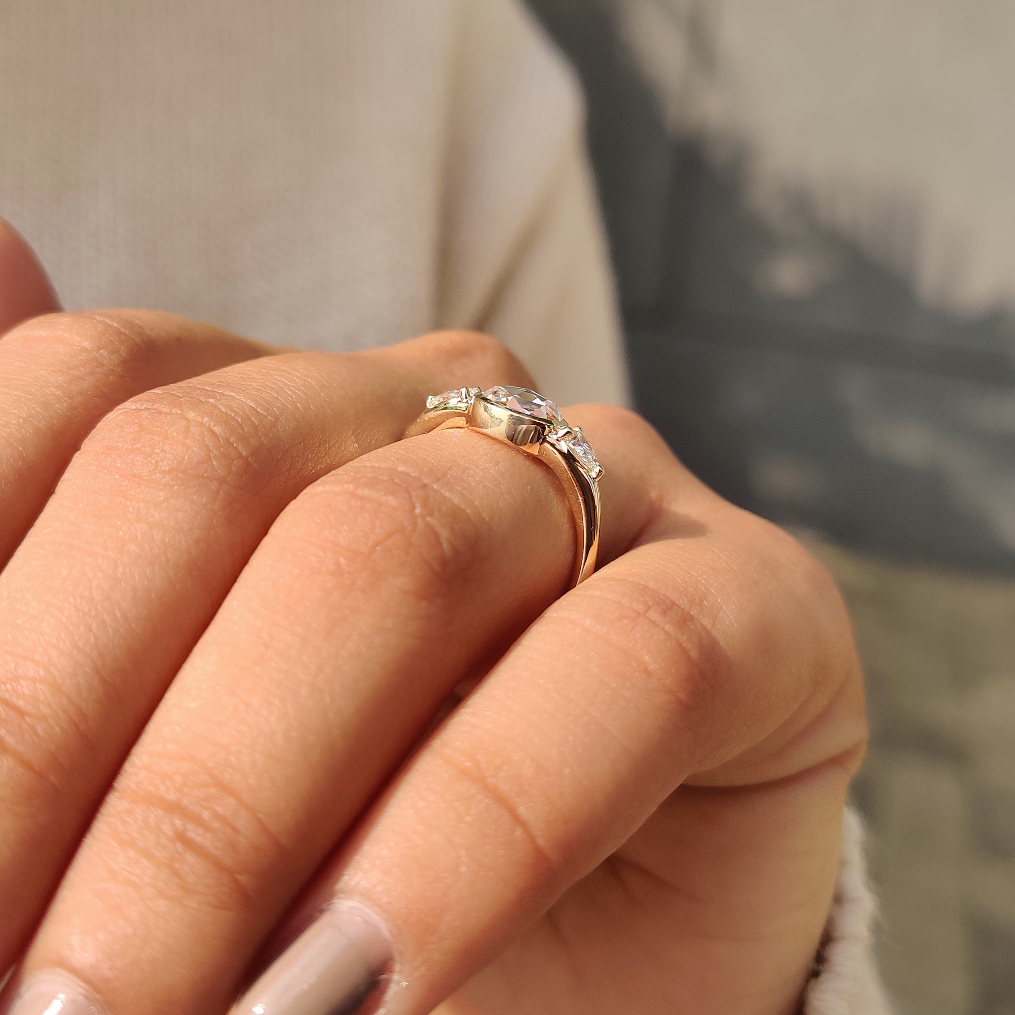 Prong setting ring with pear side stones.
