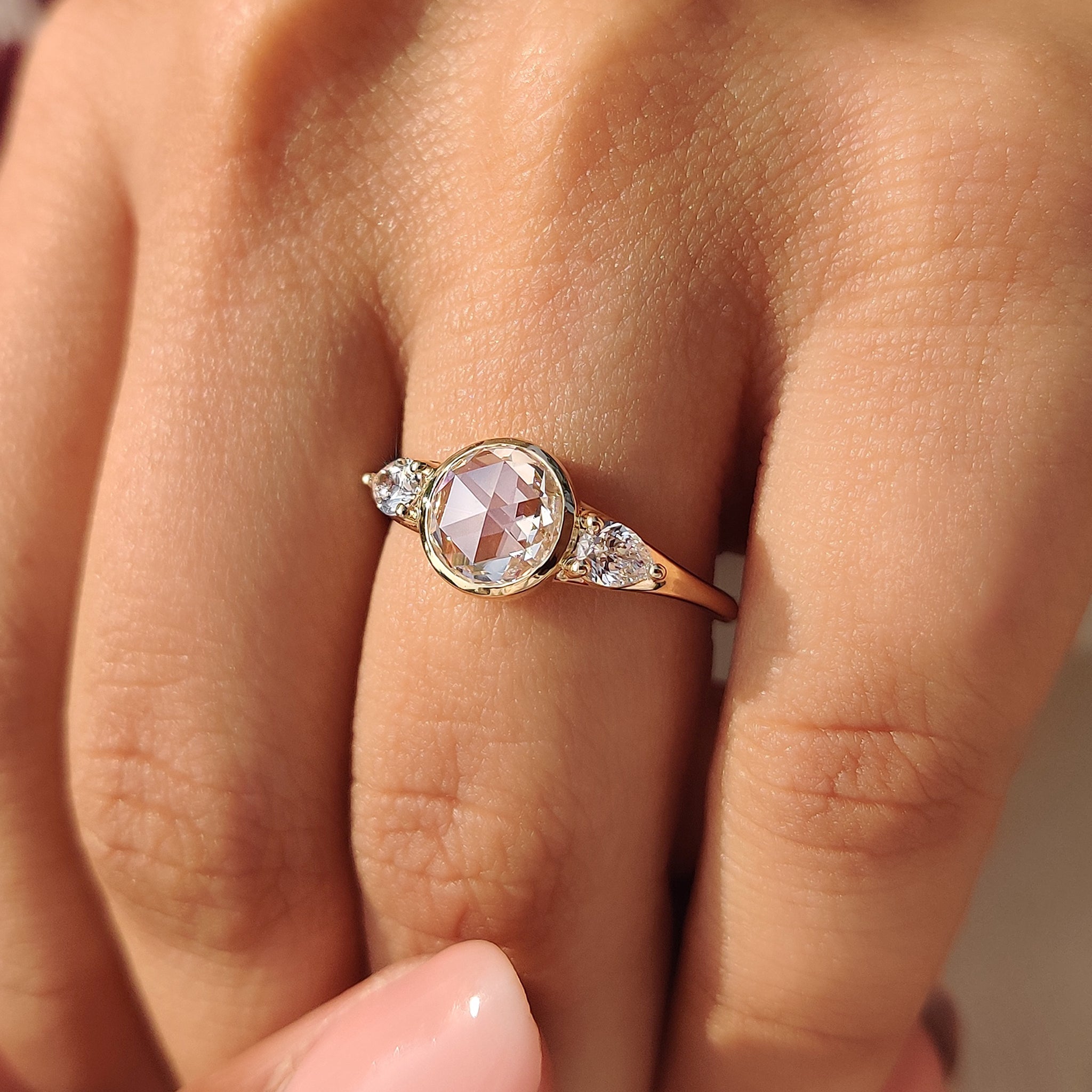 Three stone engagement ring with rose cut diamonds.
