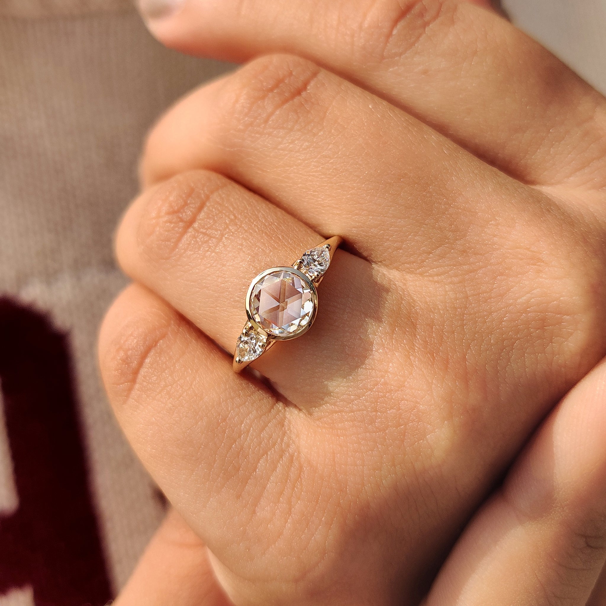 Yellow gold ring with a bezel set diamond.
