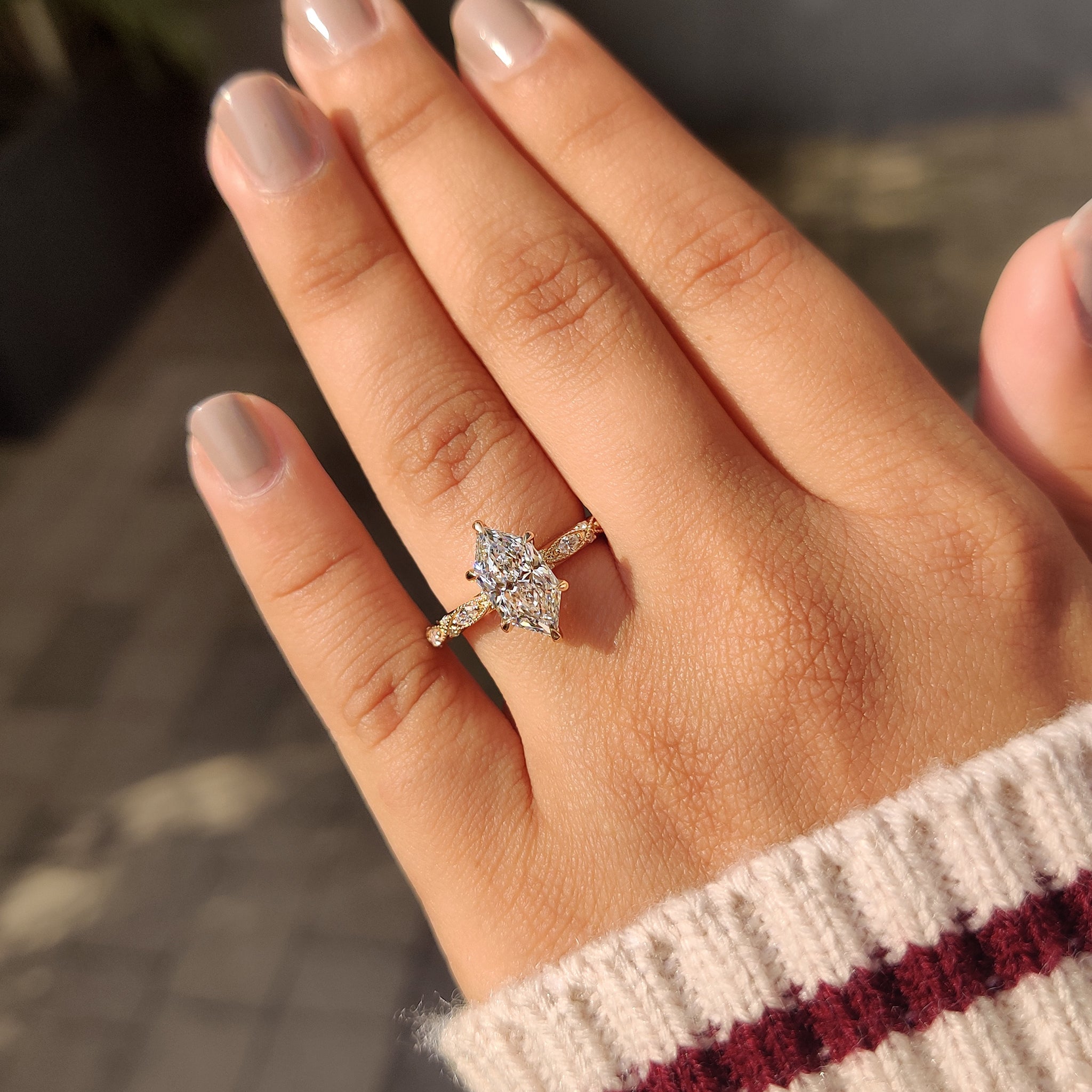 Diamond engagement ring with marquise side stones.
