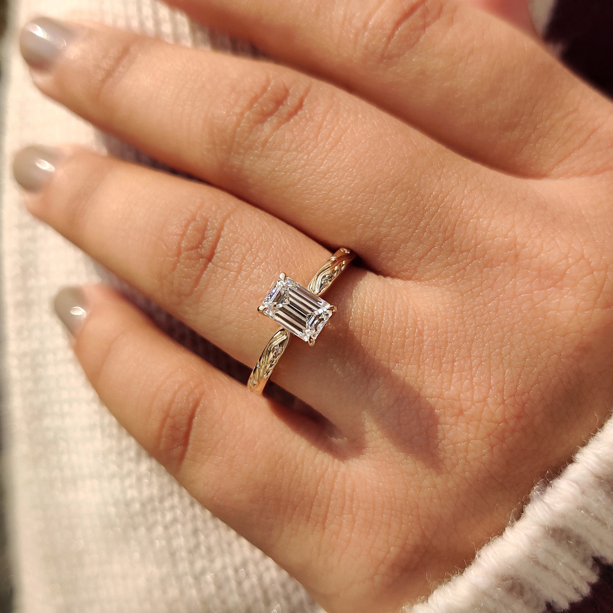 Art deco diamond ring featuring an emerald cut center.
