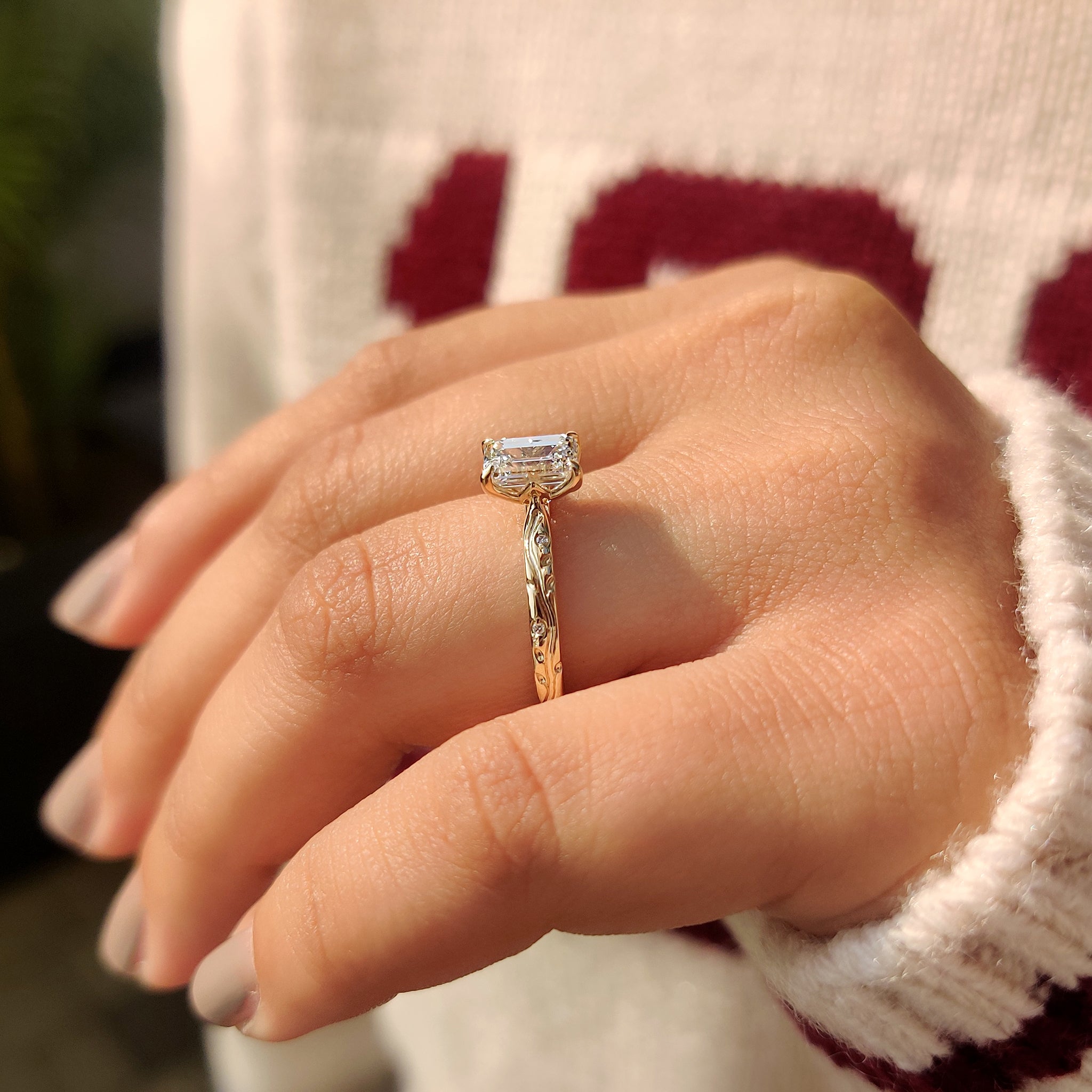 Tulip basket engagement ring with an emerald cut diamond.
