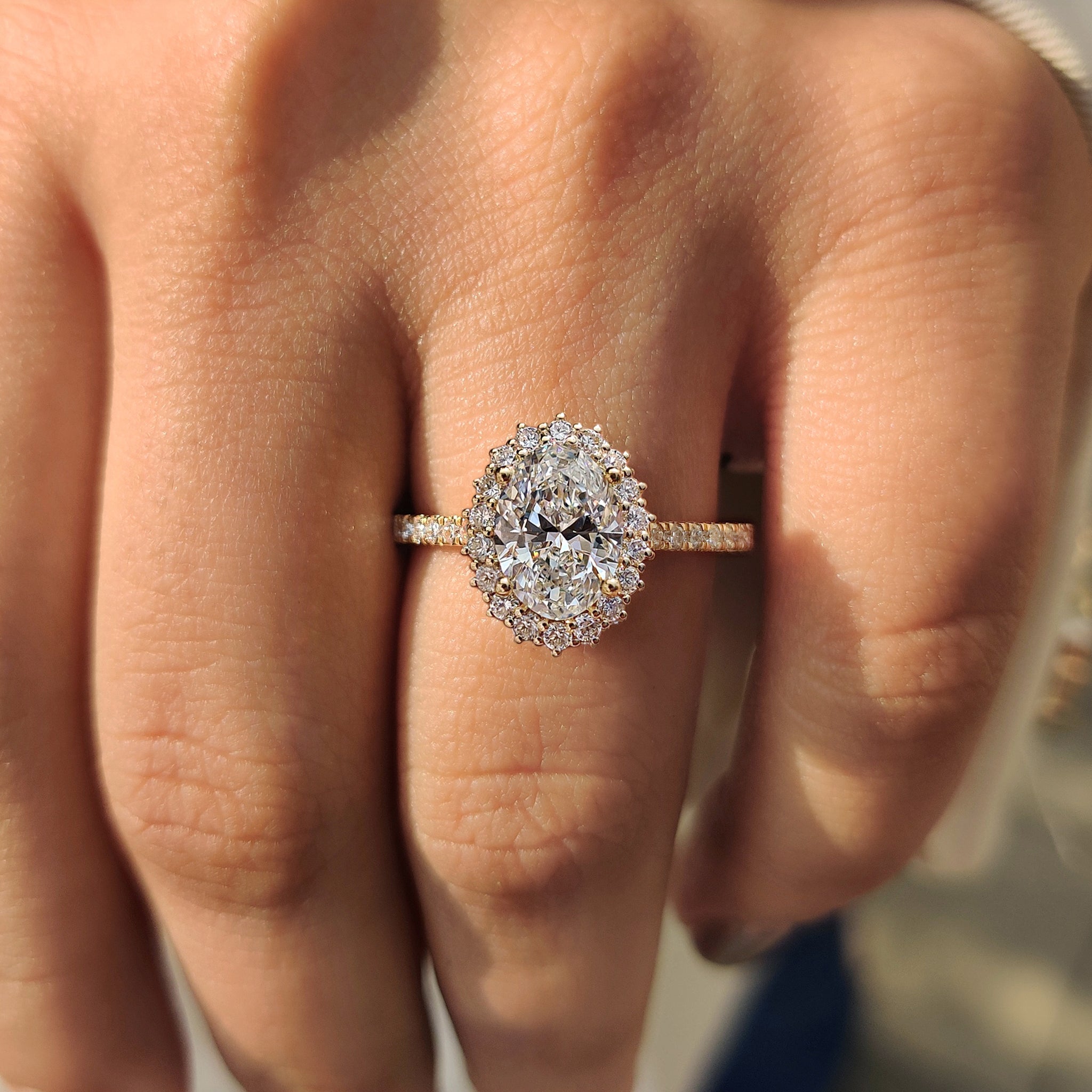 Oval cut diamond halo setting engagement ring.
