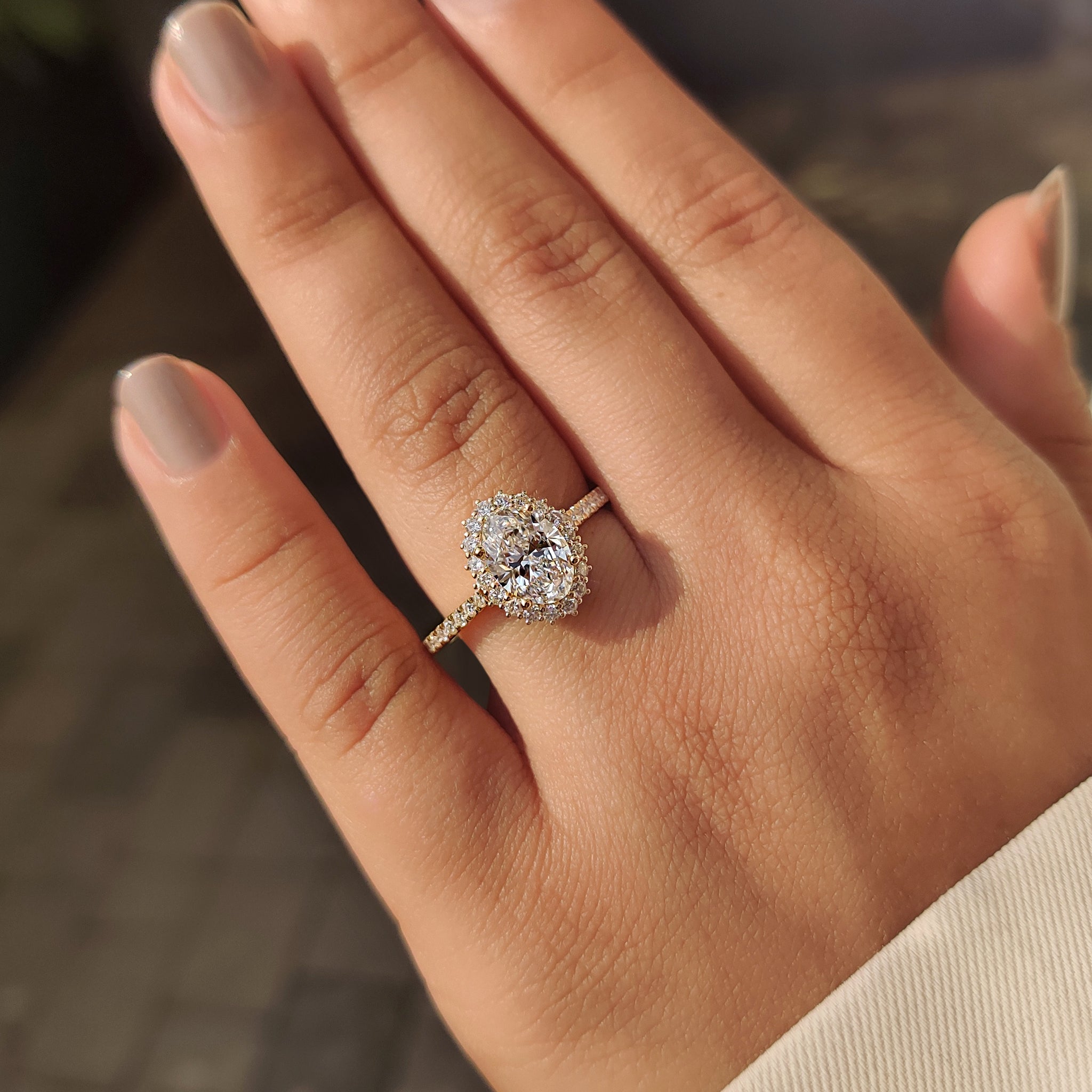 Oval cut diamond halo setting engagement ring.
