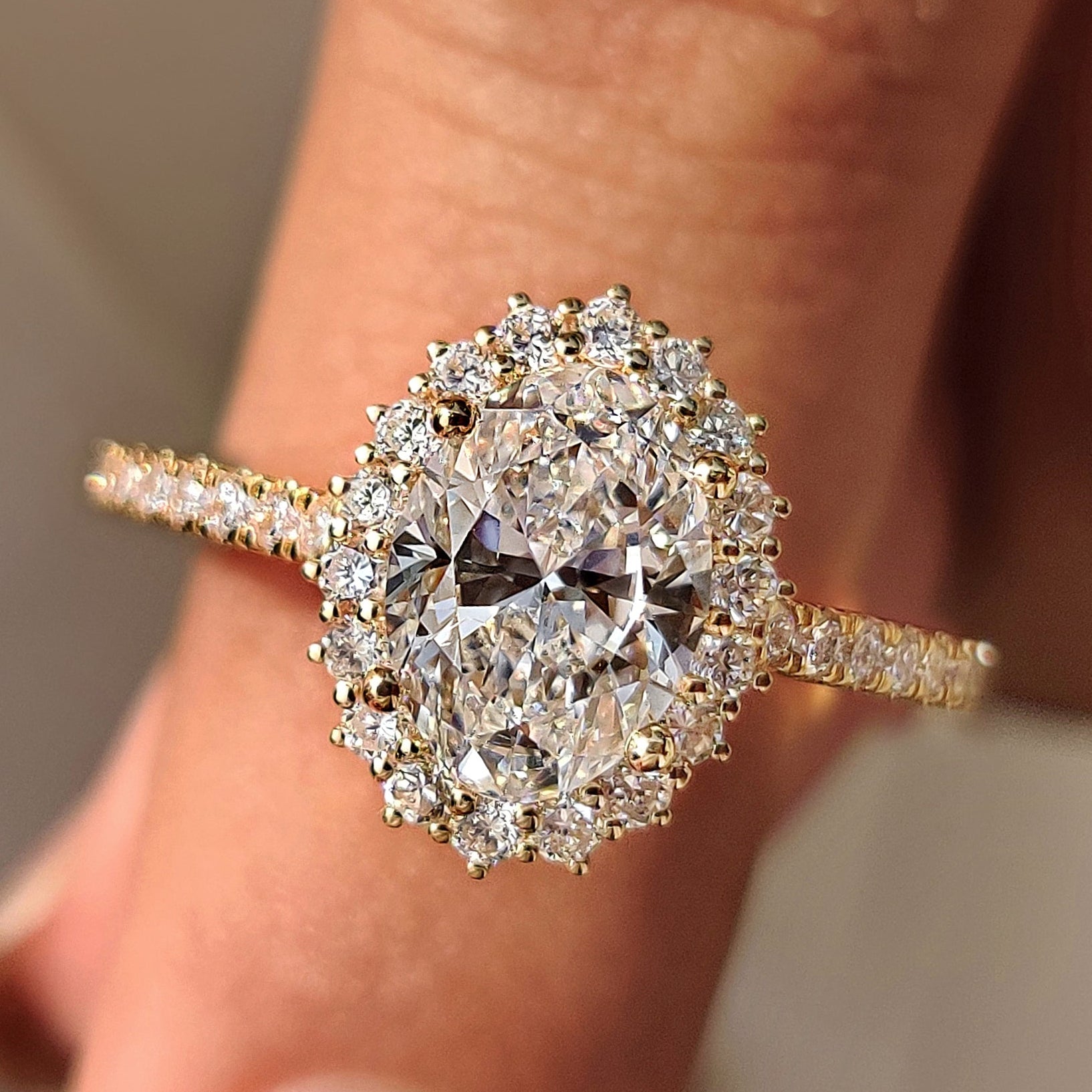 Oval cut diamond engagement ring with round cut halo setting.
