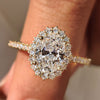Oval cut diamond engagement ring with round cut halo setting.
