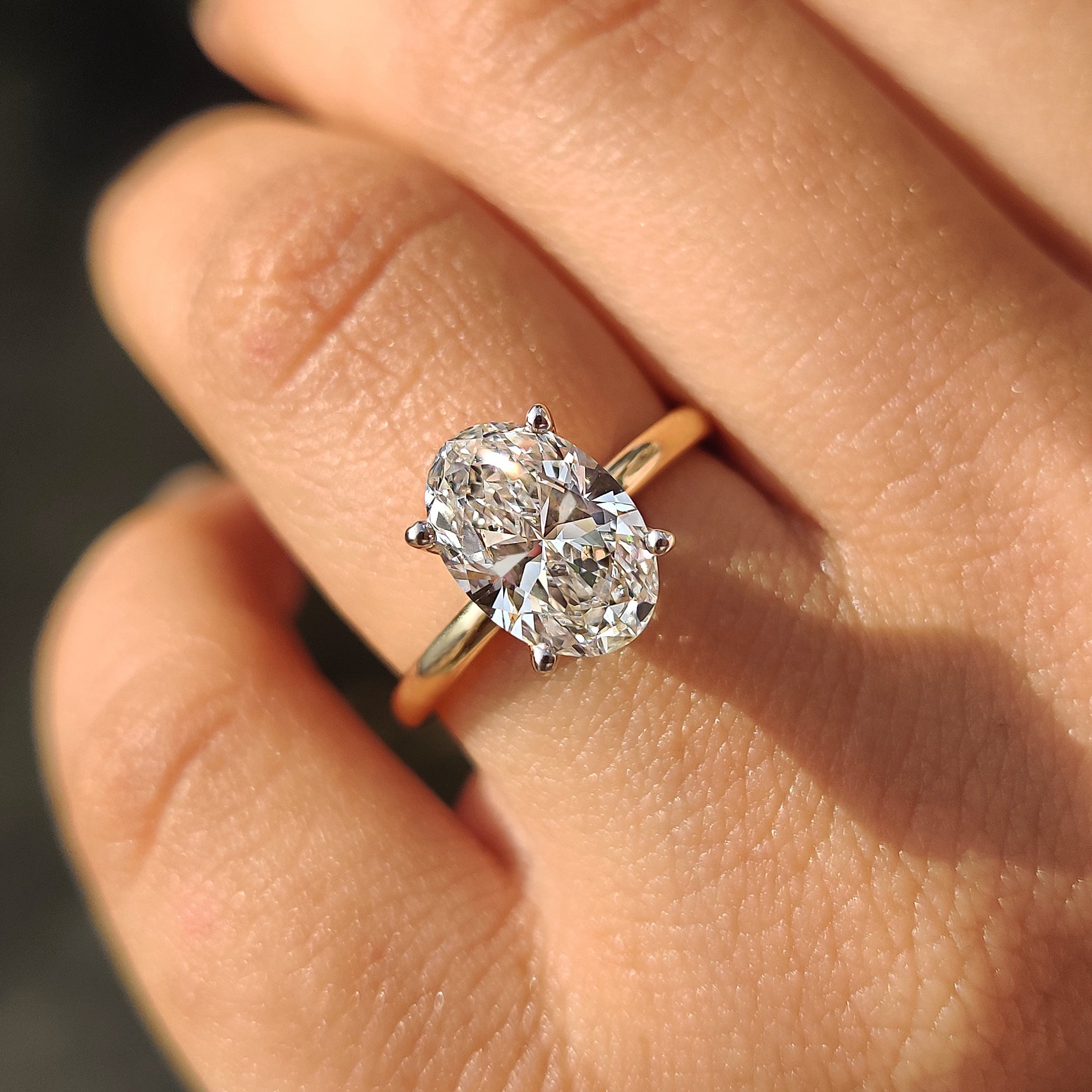 Hidden halo ring with an oval diamond center.
