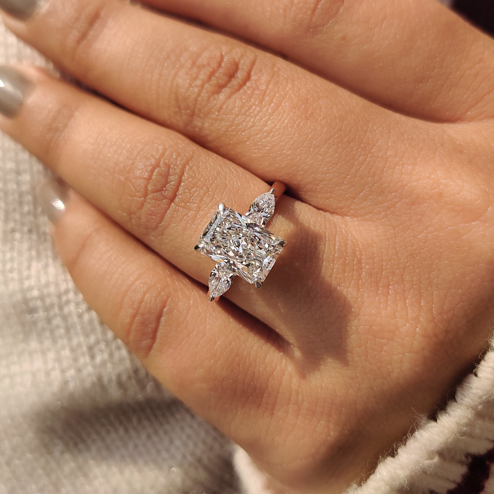 Cathedral setting ring with radiant cut diamond.
