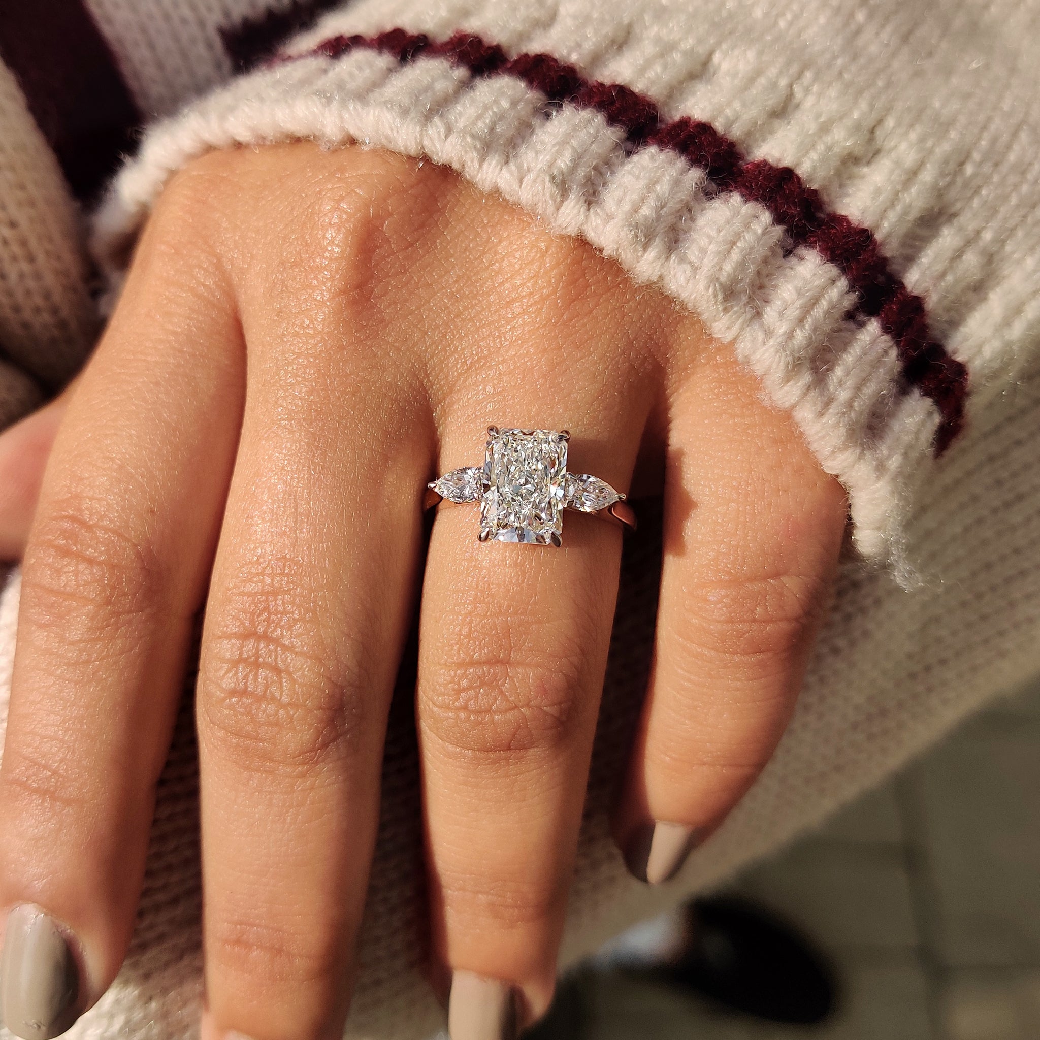 Radiant cut diamond engagement ring with cathedral setting.

