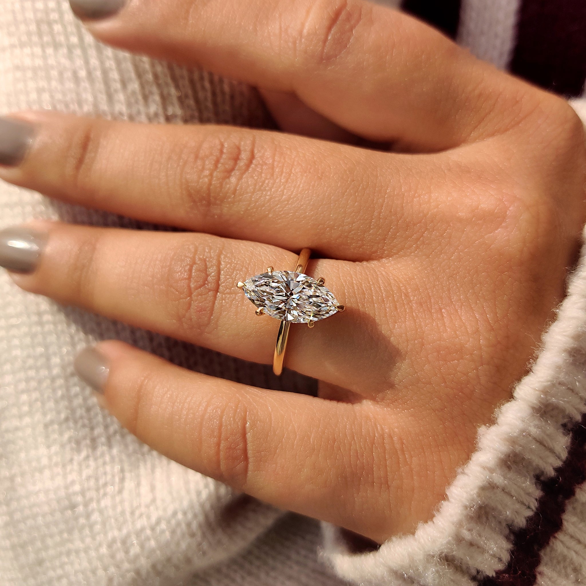 Solitaire engagement ring with a marquise diamond.
