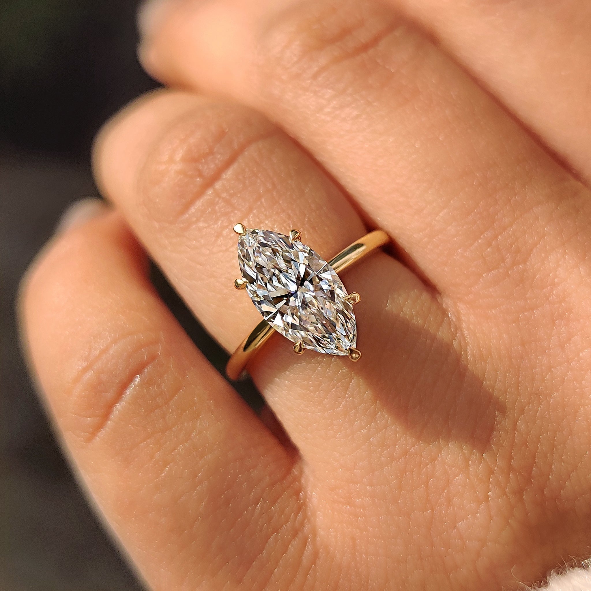 Marquise diamond solitaire ring in yellow gold.
