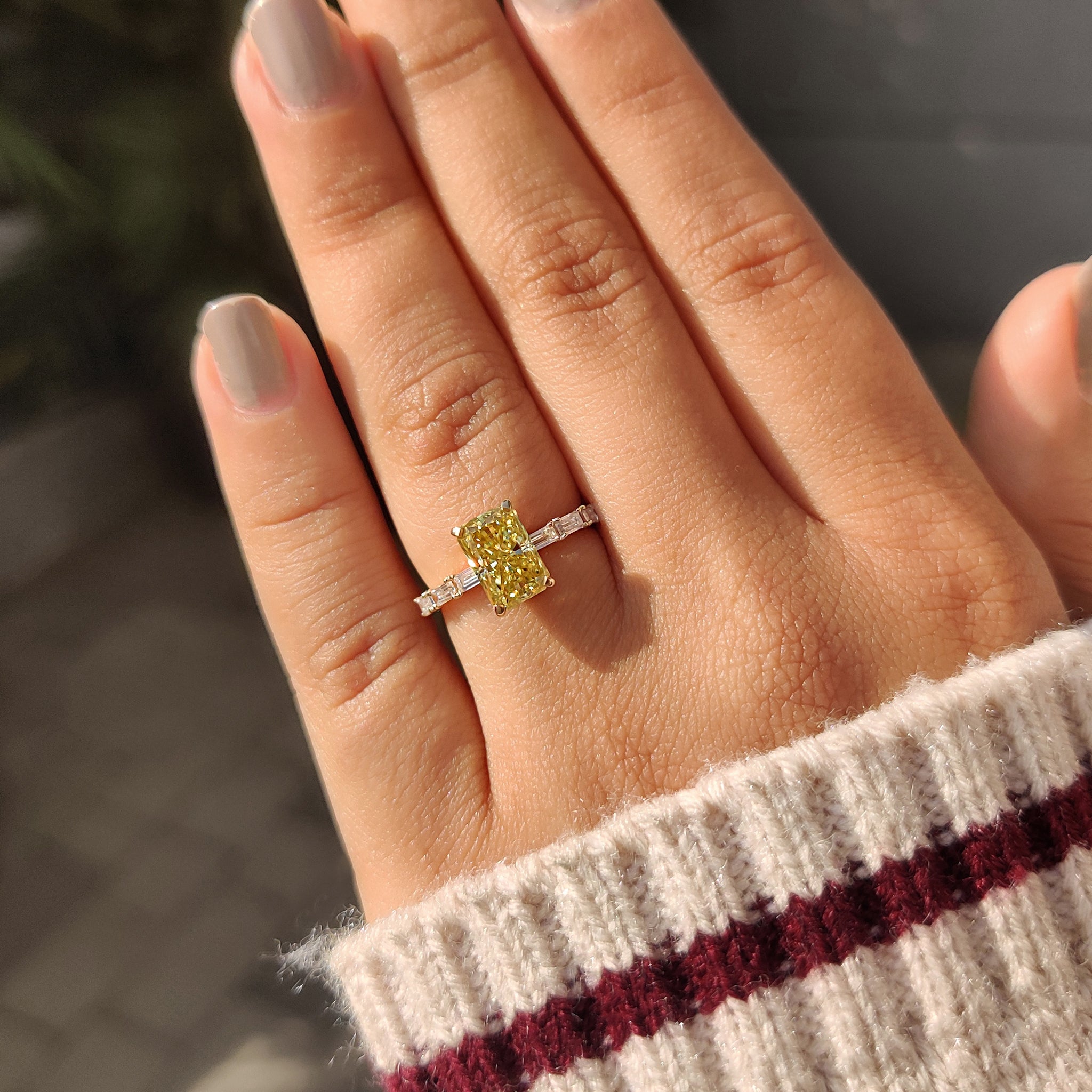 Radiant cut moissanite engagement ring in baguette cut pave setting.

