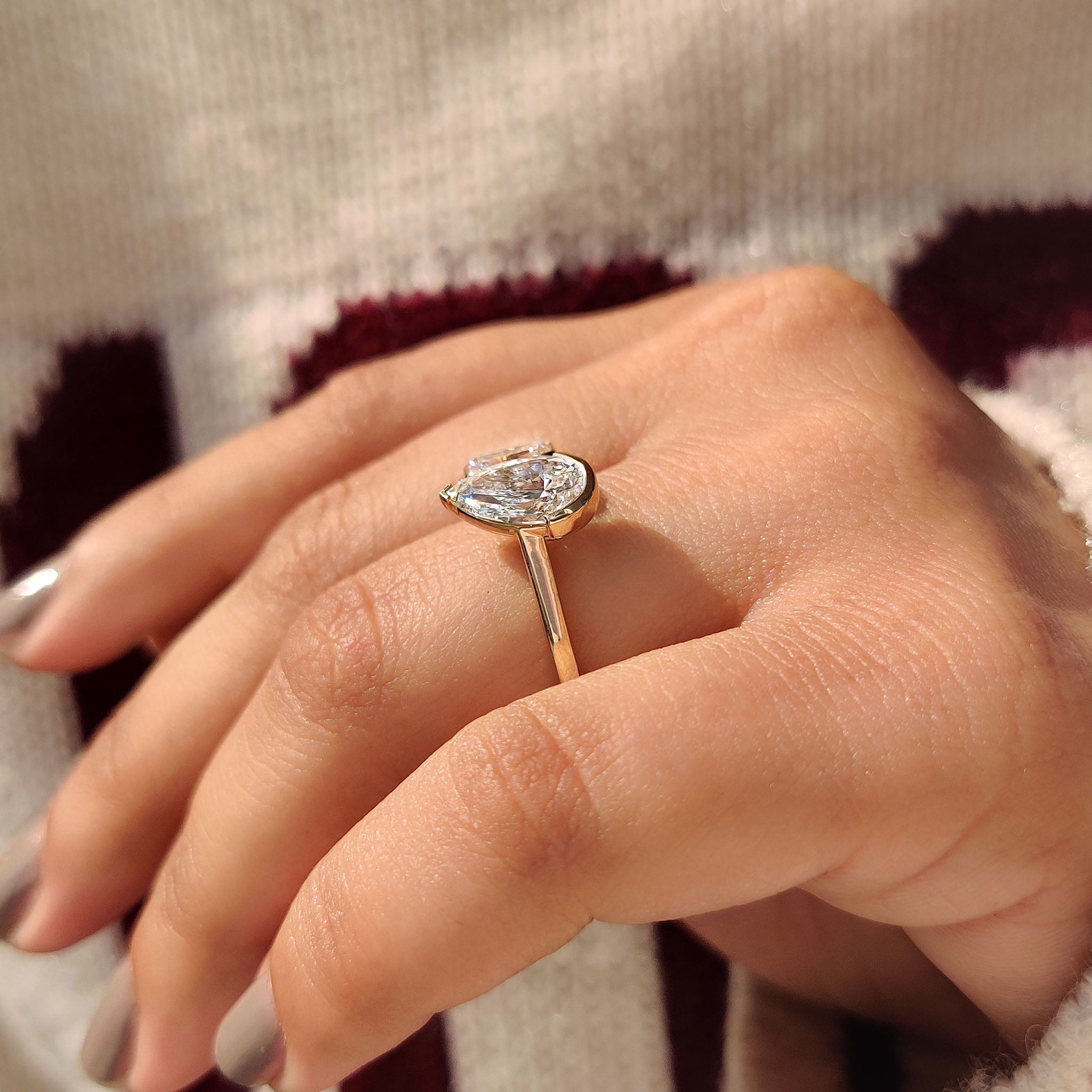 Emerald cut engagement ring with a cathedral setting.
