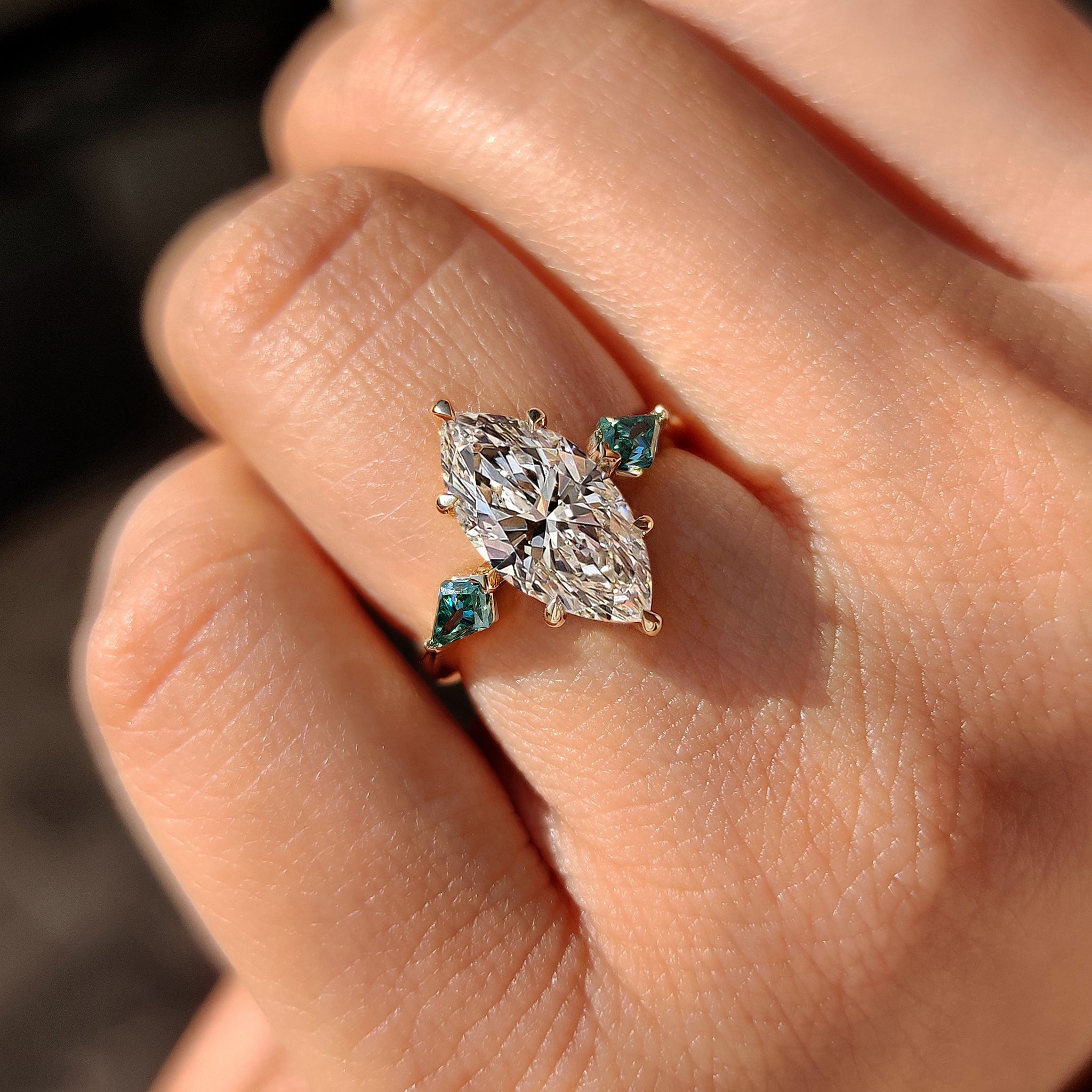 Kite cut engagement ring with marquise center diamond.
