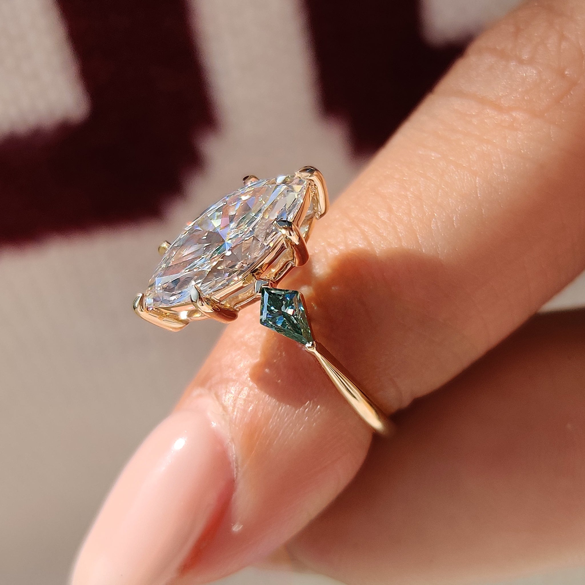 Diamond engagement ring with kite cut side moissanite.
