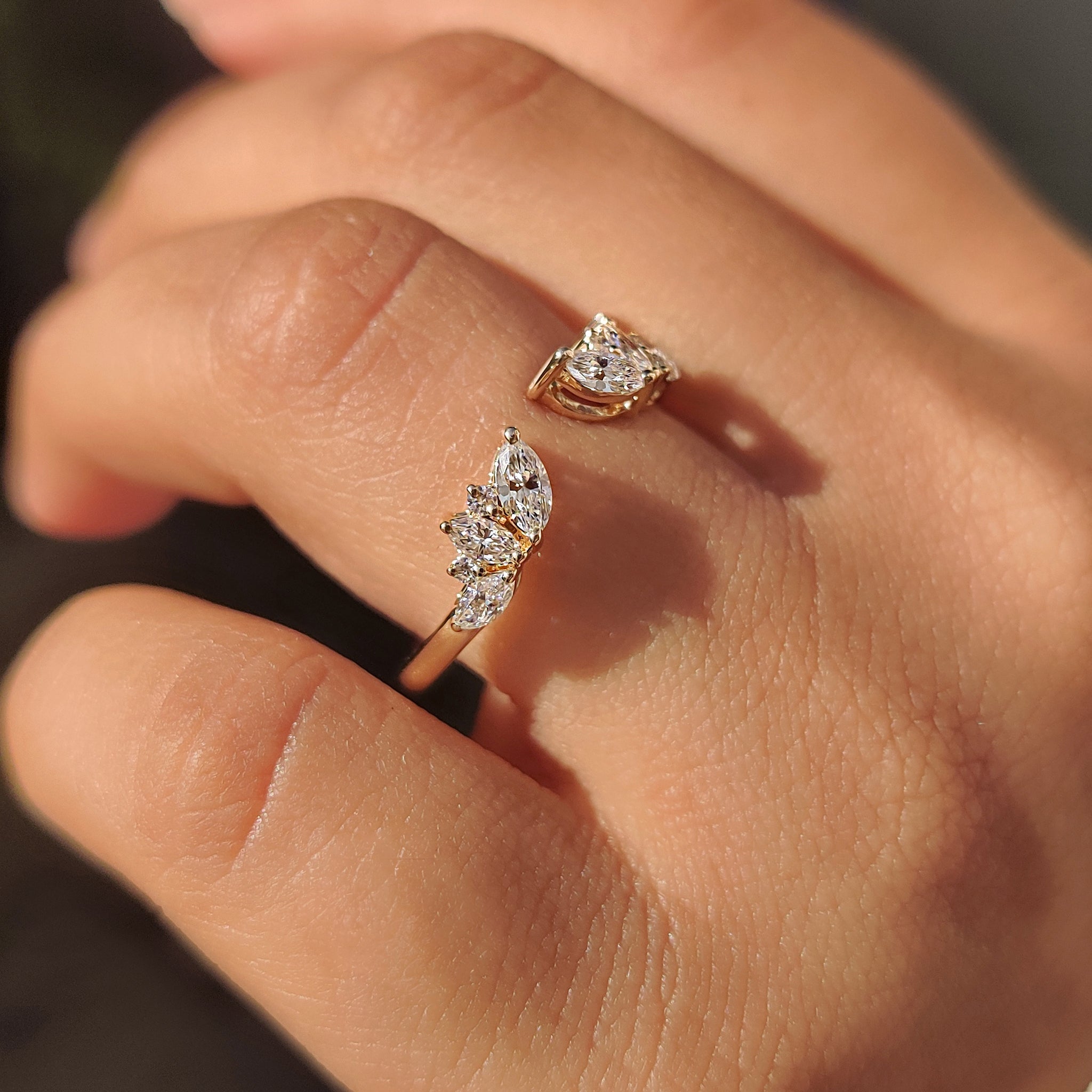 Open gap wedding band crafted with marquise and round diamond stones.
