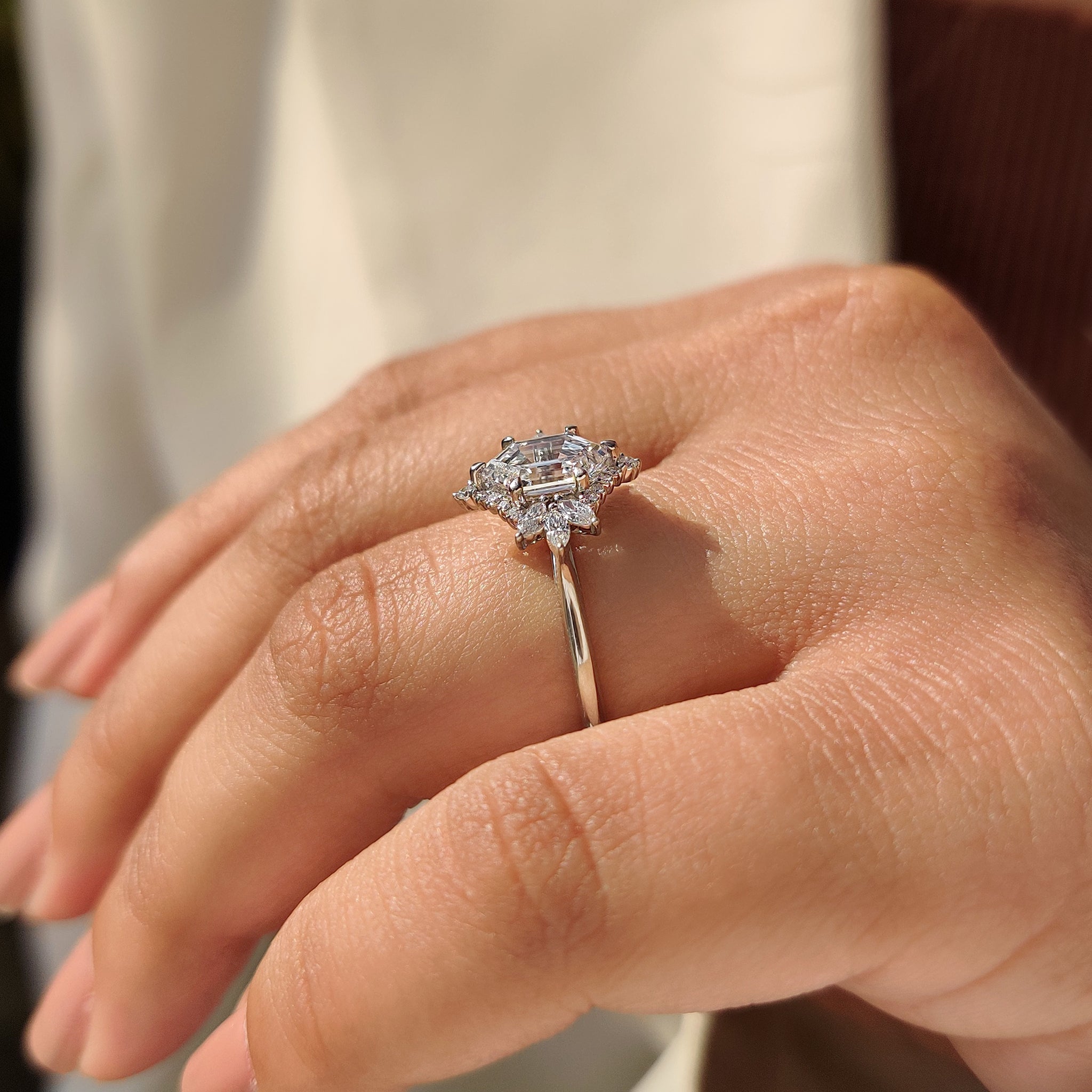 Round cut cluster setting in elongated hexagon engagement ring.
