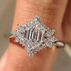 Elongated hexagon engagement ring with cluster setting design.
