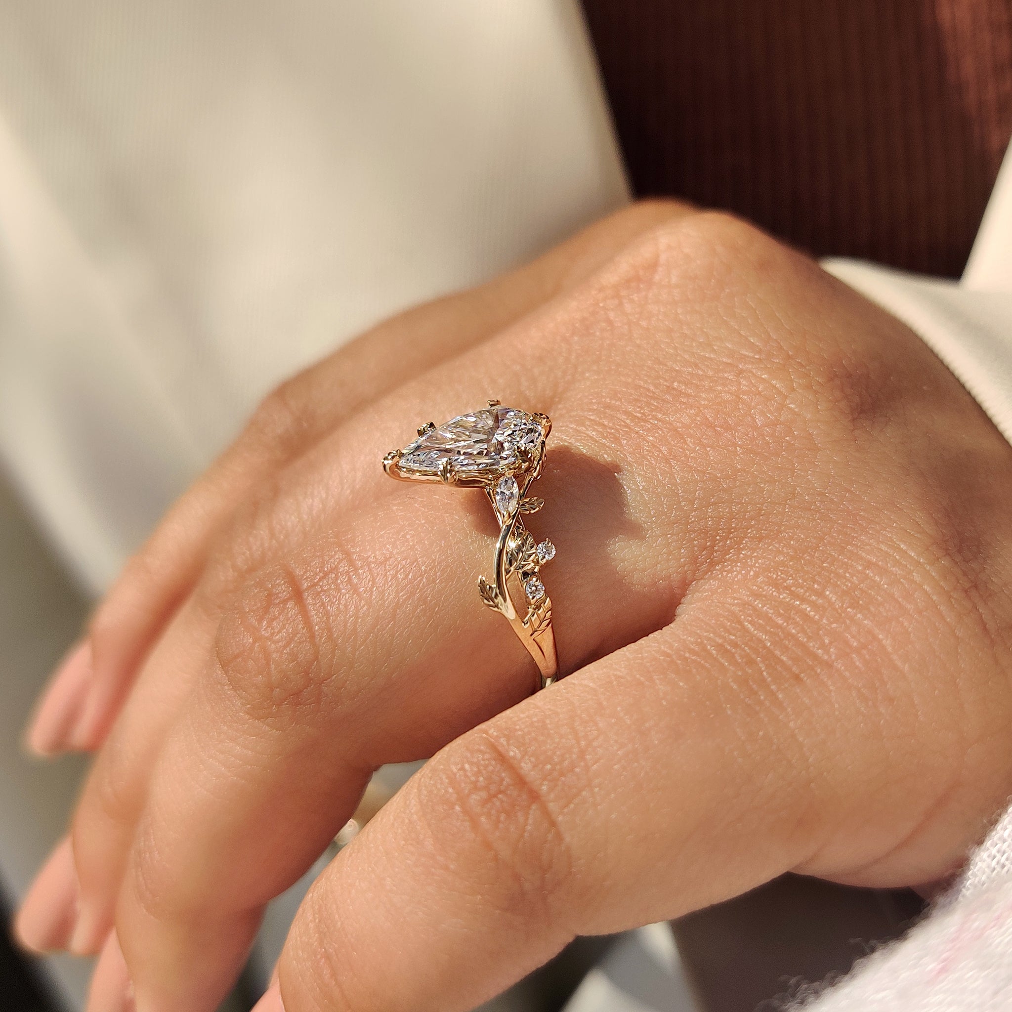 Nature inspired engagement ring with 6 leaf style prong setting.
