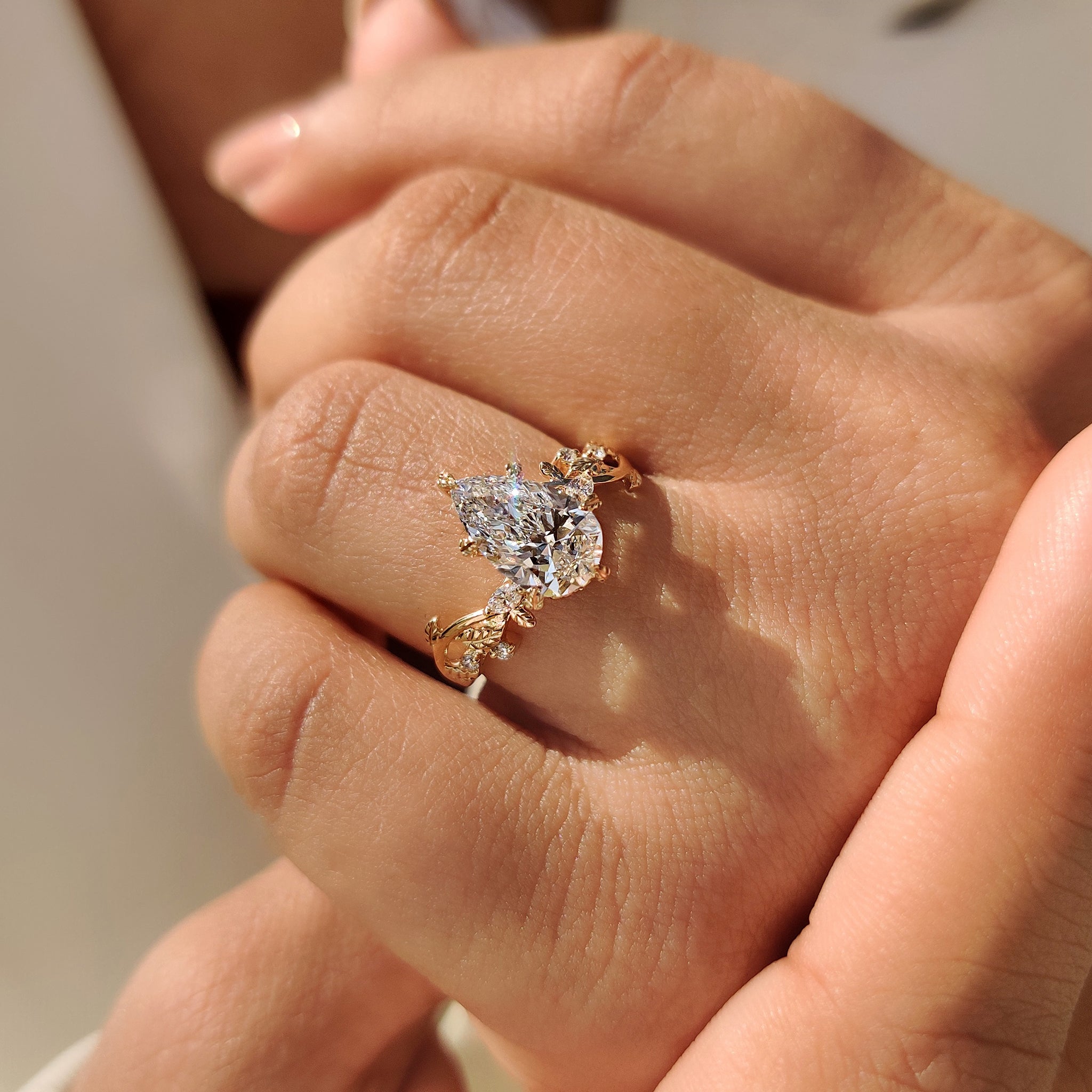 Handmade jewelry ring with marquise and round side stone layout.
