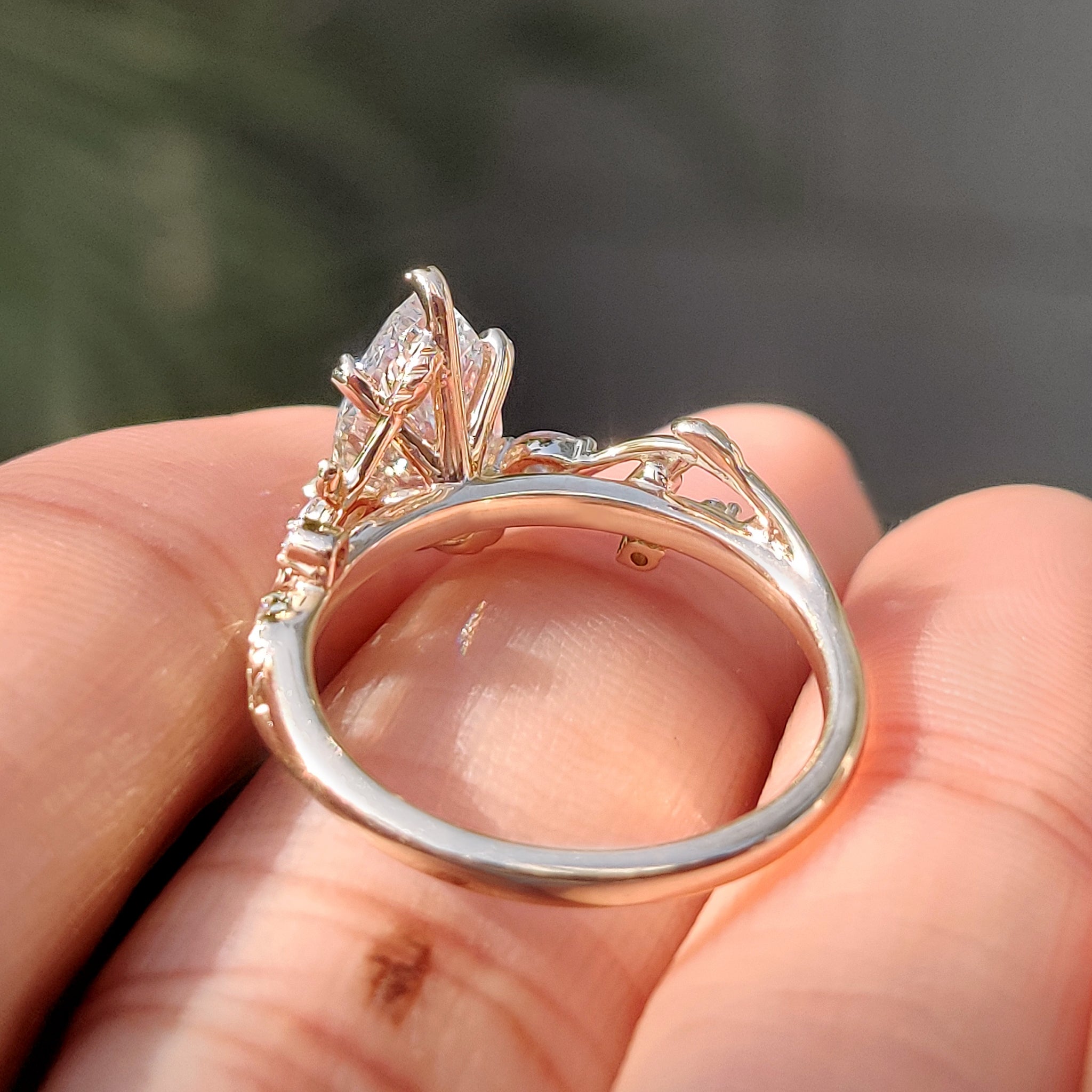 Pear diamond ring with elegant leaf style prong setting.
