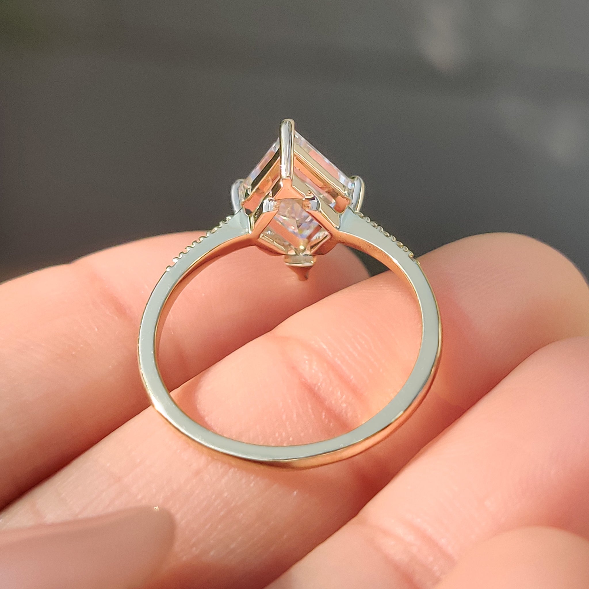Lab grown lozenge cut diamond ring with pave band.
