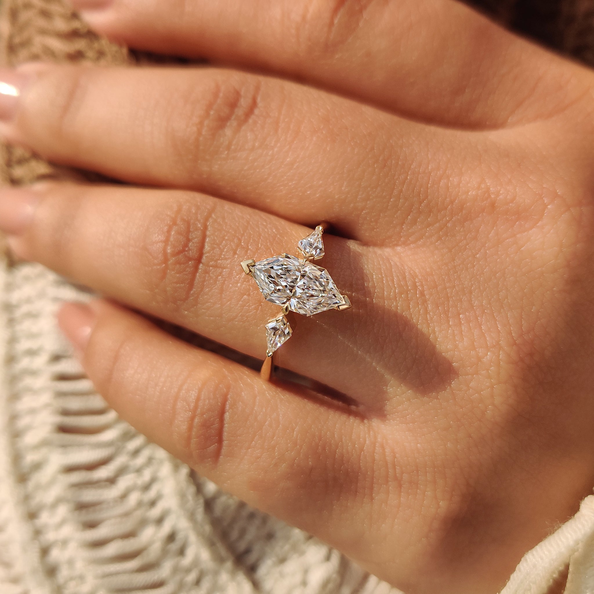 Three diamond ring with 2 v shaped prong and 2 claw prong setting.
