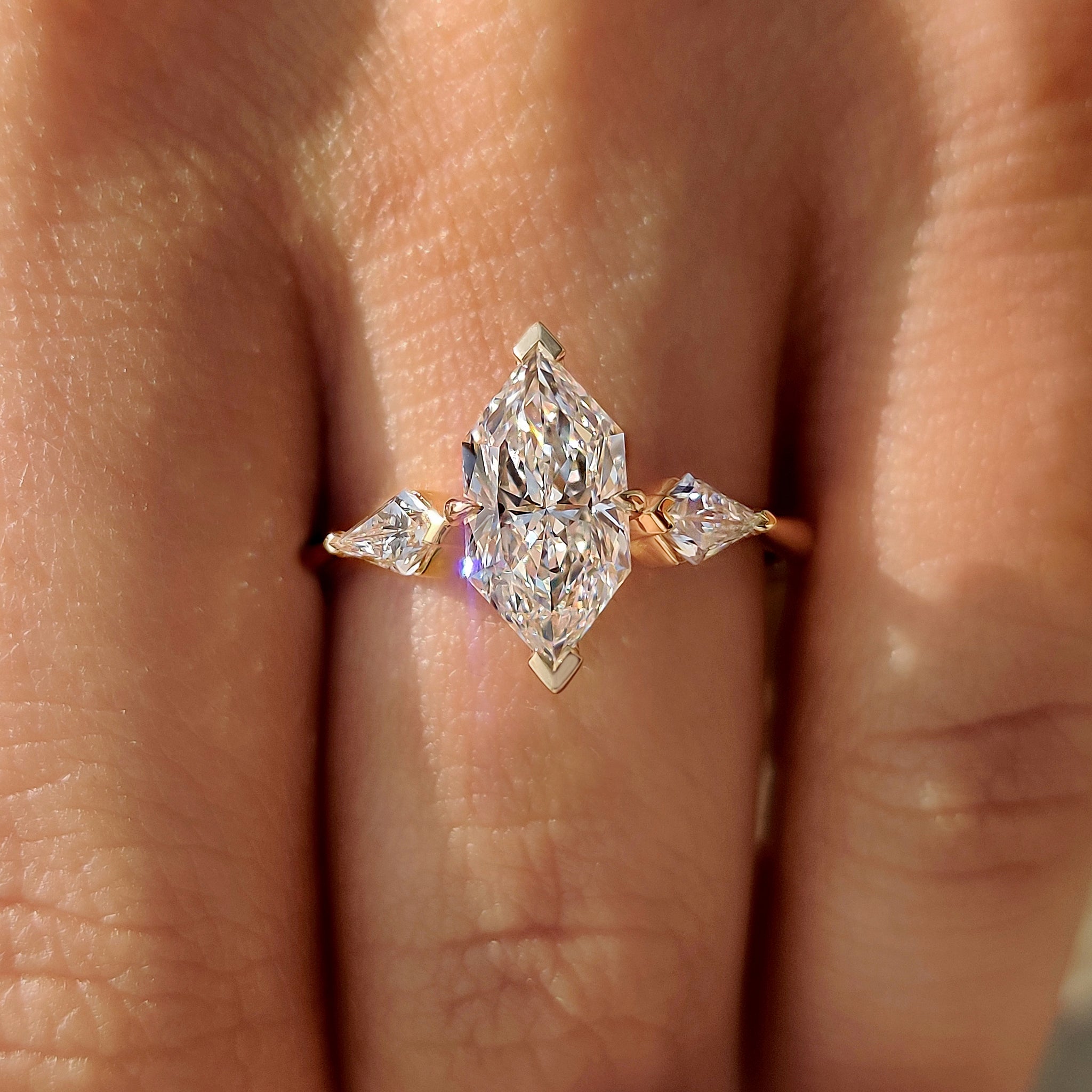 Dutch marquise center diamond ring with tapered shank design.
