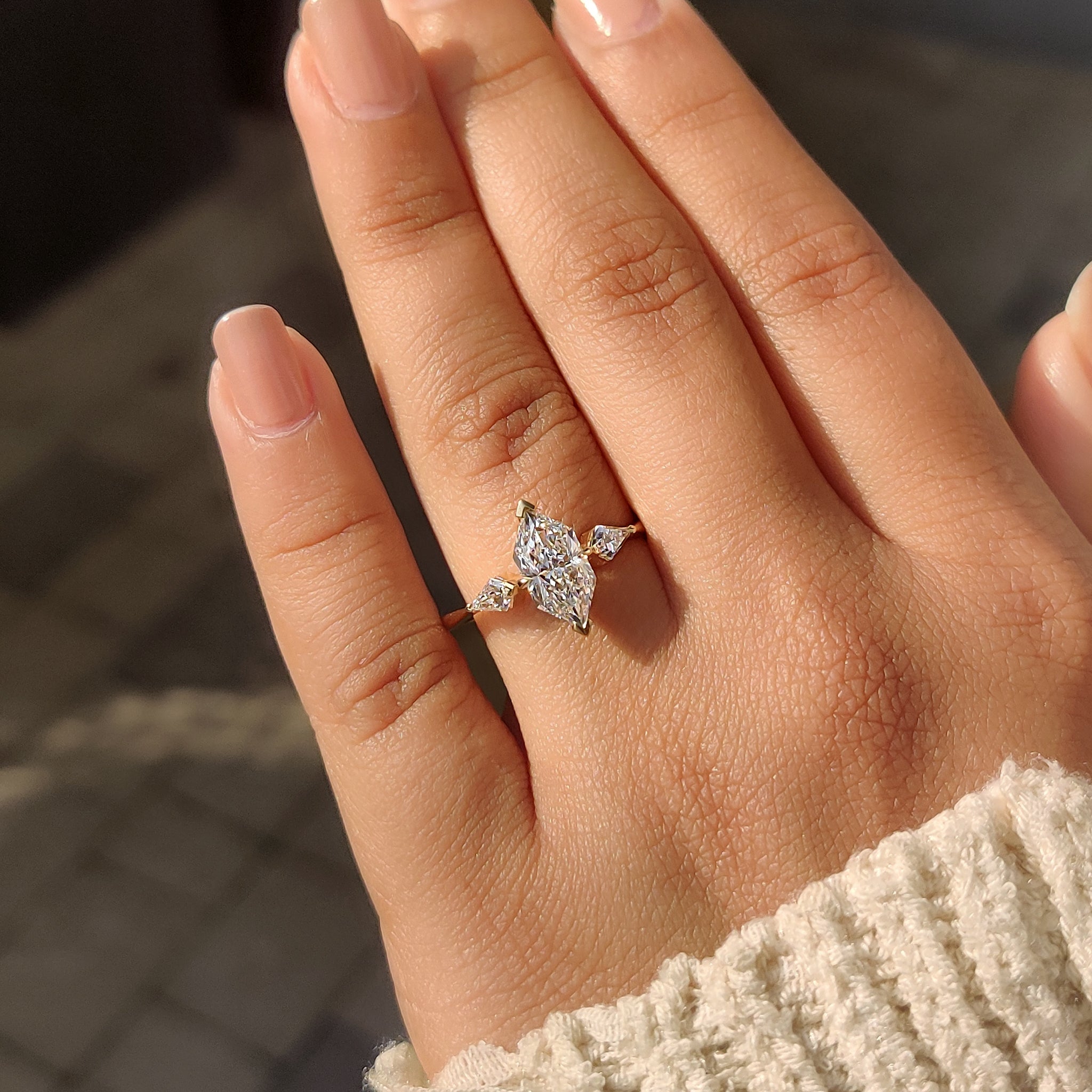 Three diamond ring with unique v shaped and claw prong settings.
