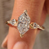 Three diamond ring with dutch marquise center diamond and kite cut side diamond.

