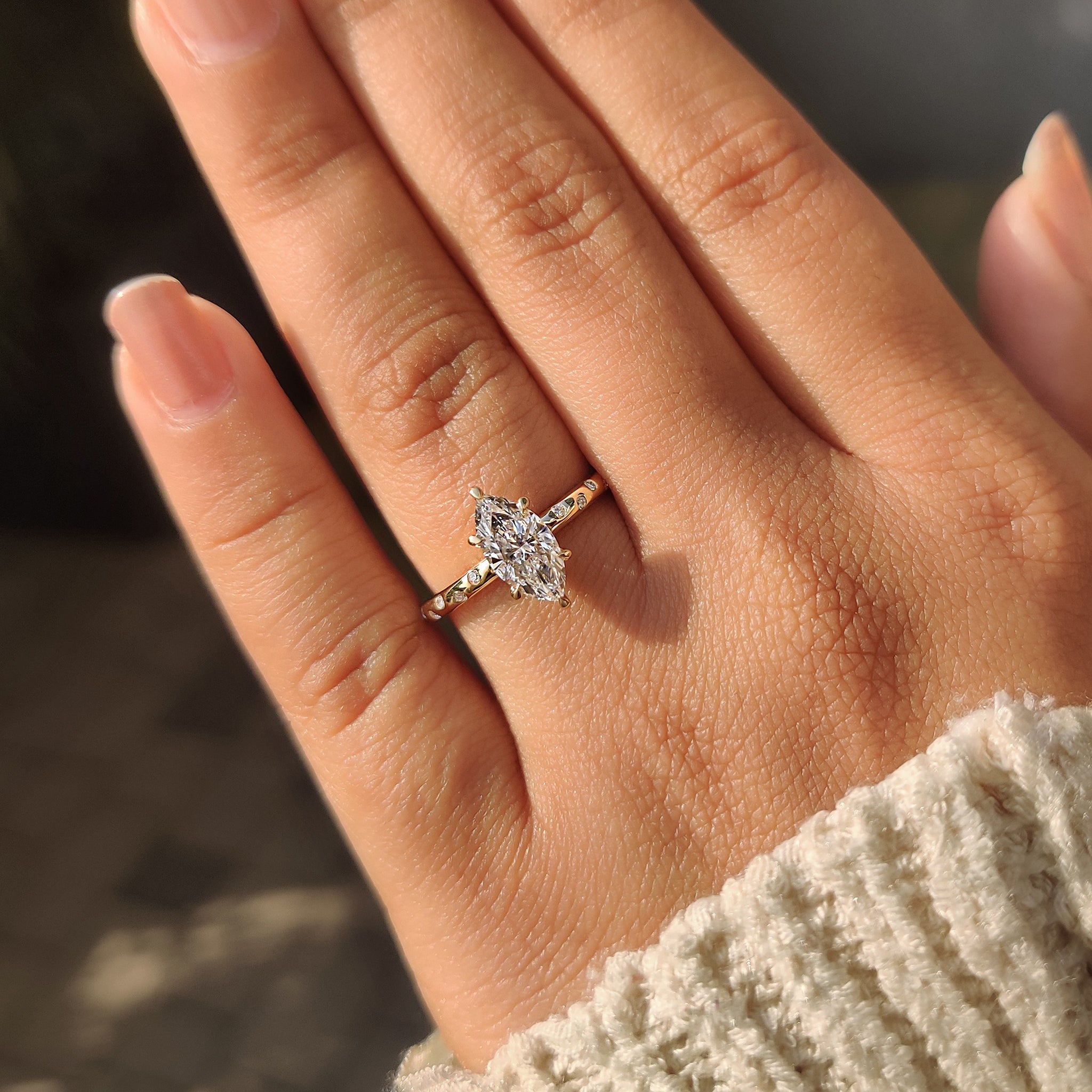 Marquise diamond ring 6 claw prong setting and round cut side diamonds.
